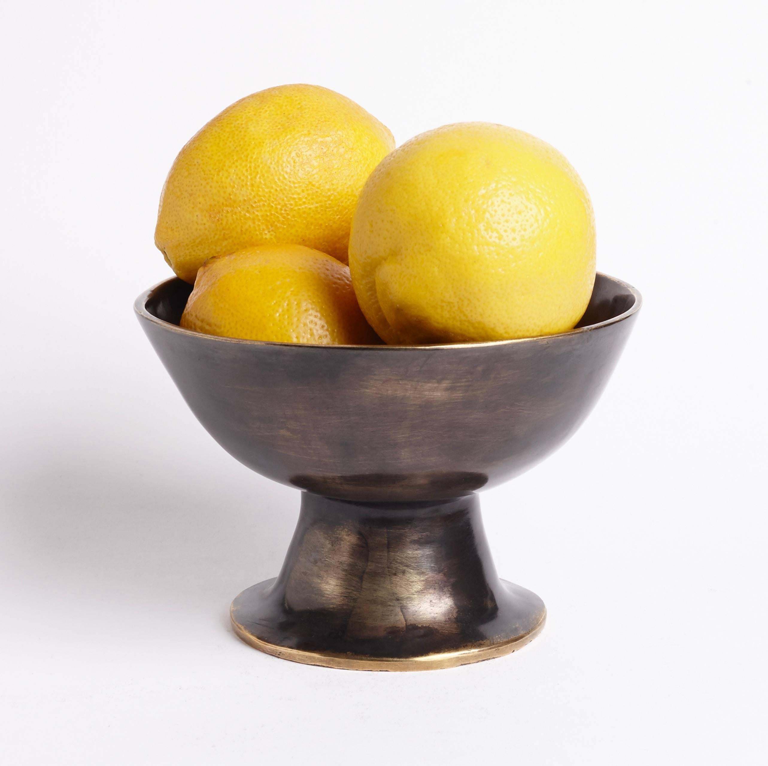 Recalling polychrome Pre-Columbian clay vessels, the elegant shape of this hand-forged cast-brass footed bowl has a sculptural quality that makes it ideal for display on a nightstand, vanity, desk, or entry table.