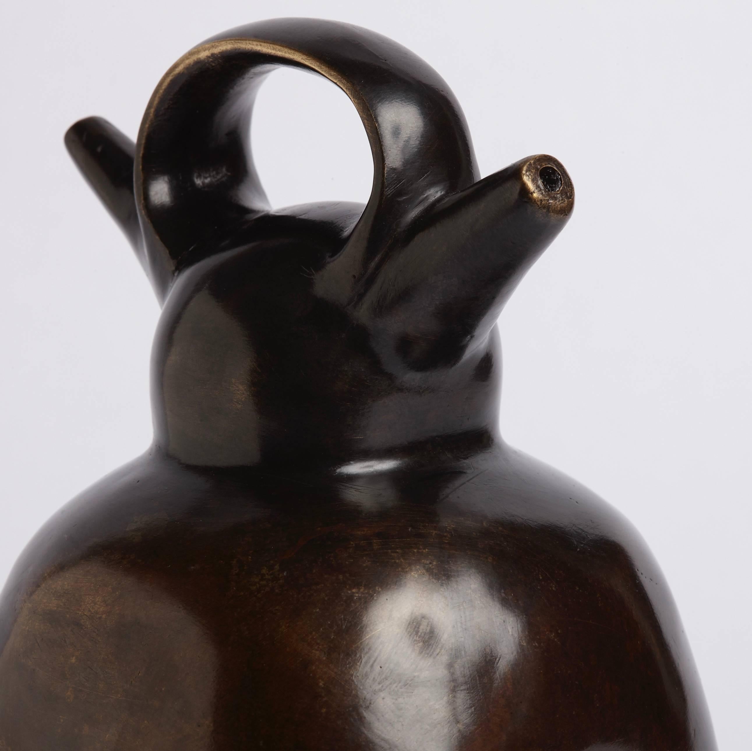 Inspired by the ceramic stirrup vessels of Pre-Columbian cultures, this cast-brass objet has a sculptural elegance that will elevate any room. Place it atop a small pedestal or under a cloche to create a gallery-like installation in any room.

  
