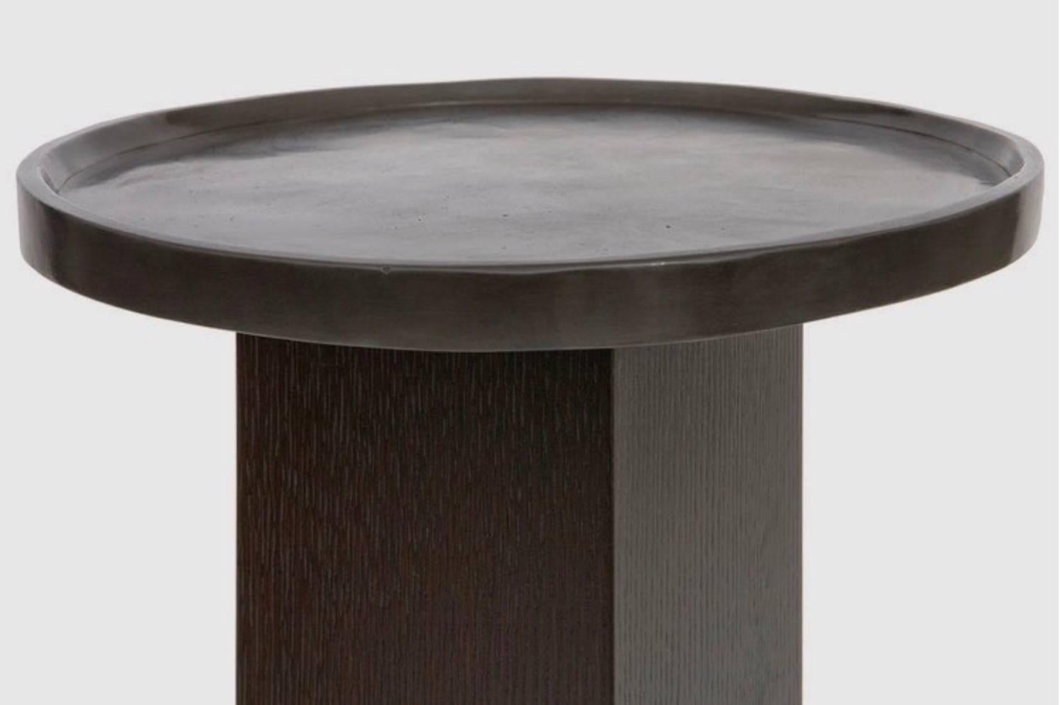 The sturdy rift-sawn oak pedestal supports a functional cast-bronze tray finished with an antiqued patina in this stylish yet sensible accent table. Use it in a living room to display decorative items such as sculptures or busts and plant-filled