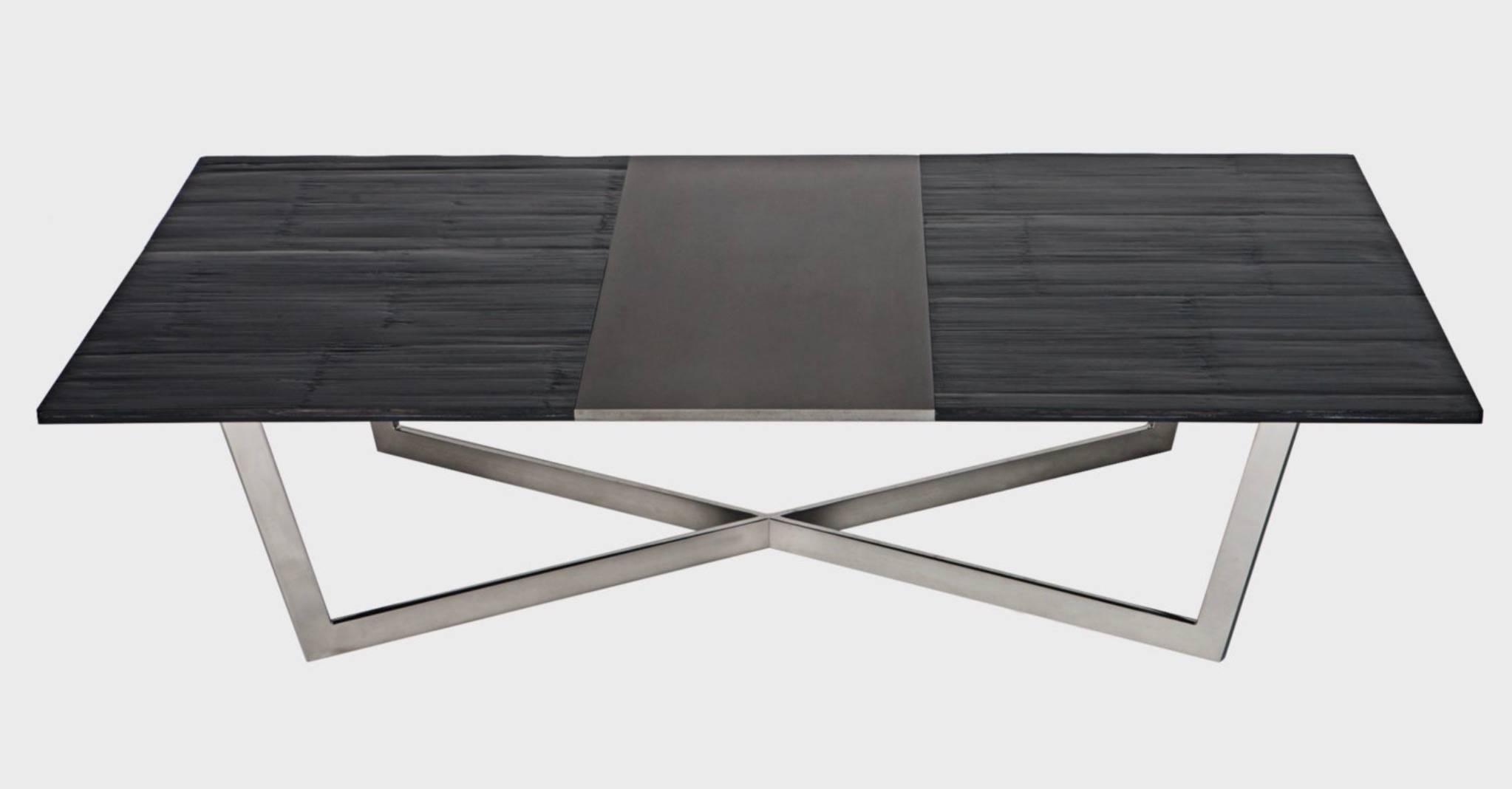 An eye-catching runner of blackened steel spans the length of this handcrafted table’s ¼-inch thick bamboo top. Its matte finish is juxtaposed against the polished luster of an X-shaped base and provides appealing contrast that plays well in