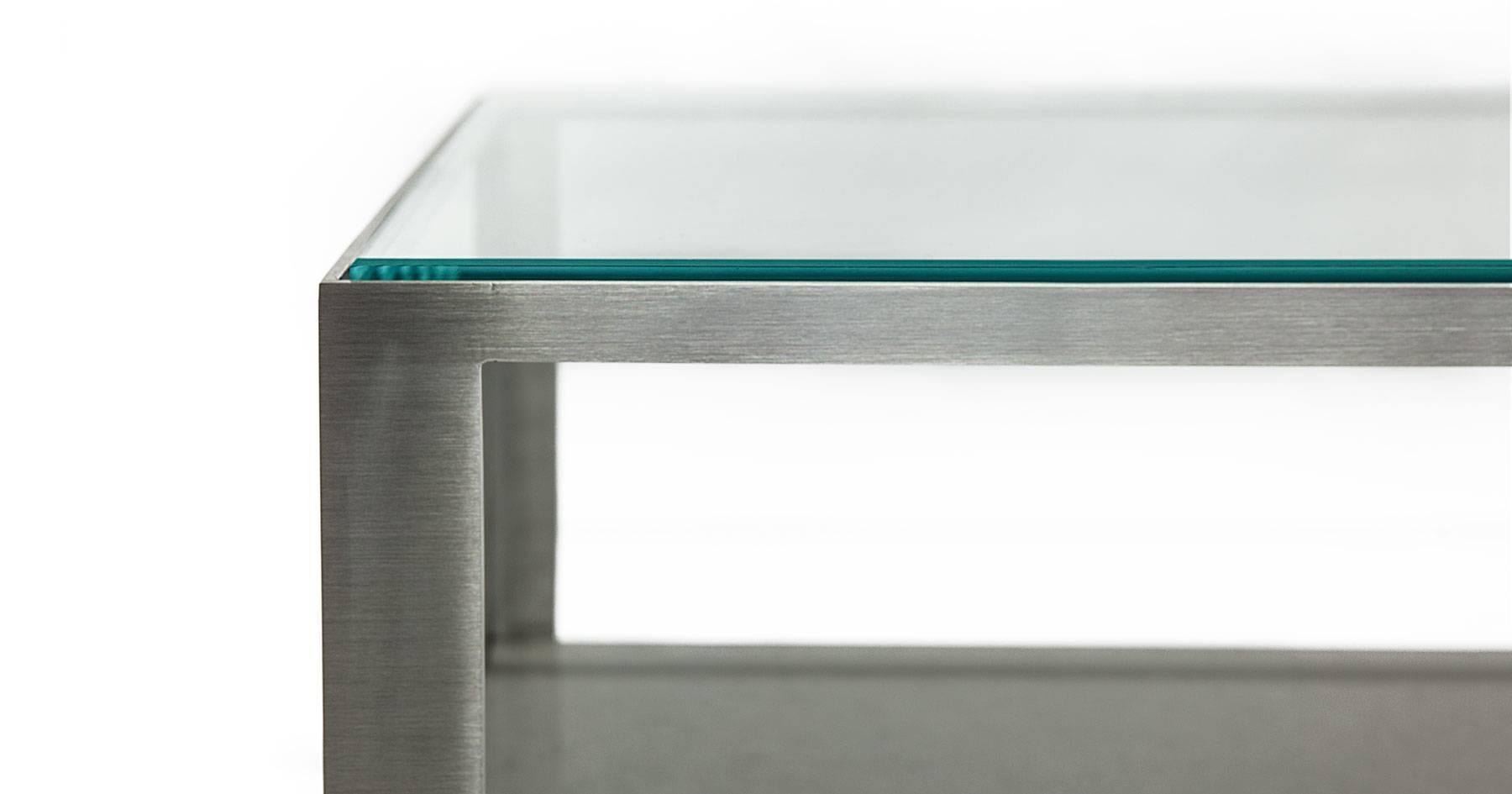 A brushed stainless steel frame and a ½-inch thick tempered glass top give the Perry coffee table sleek and streamlined look that creates a striking focal point in any living room. A 1 ½-inch gray marble shelf offers plenty of space to display books