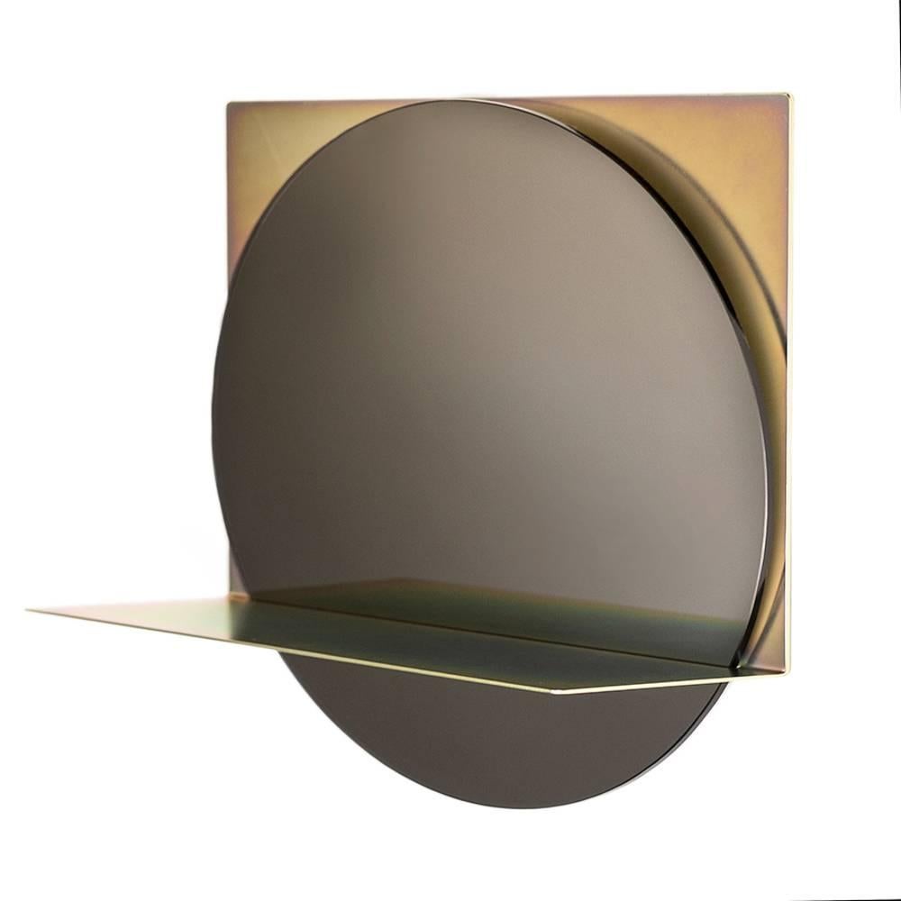 The starting point mirror is minimalist in form and luxurious in form and function.

It starts with a single piece of steel. The metal is laser cut and formed to create a cradle for the circular mirror and also give a convenient shelf for the