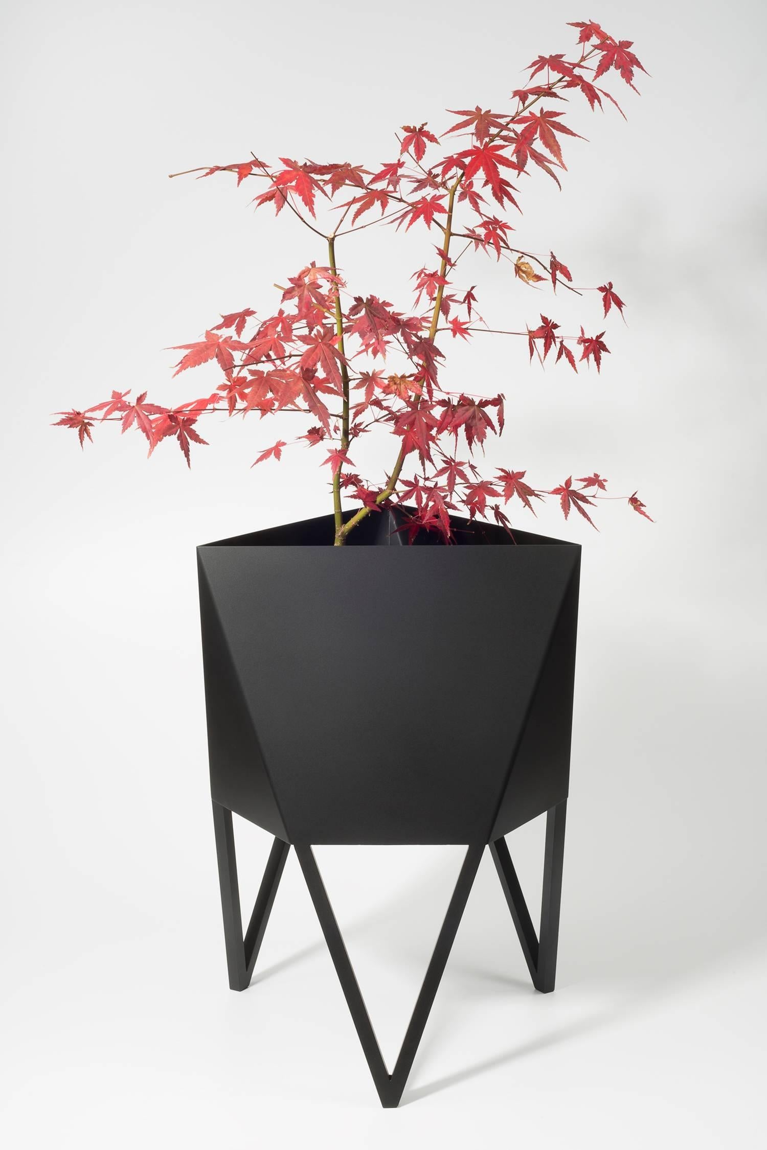 Introducing Force/Collide's signature planter in flat black. Using a seamless brake-forming technique, one sheet of steel is wrapped into a unique geometric pattern that's triangular at the top and hexagonal at the base. Three V-shaped legs