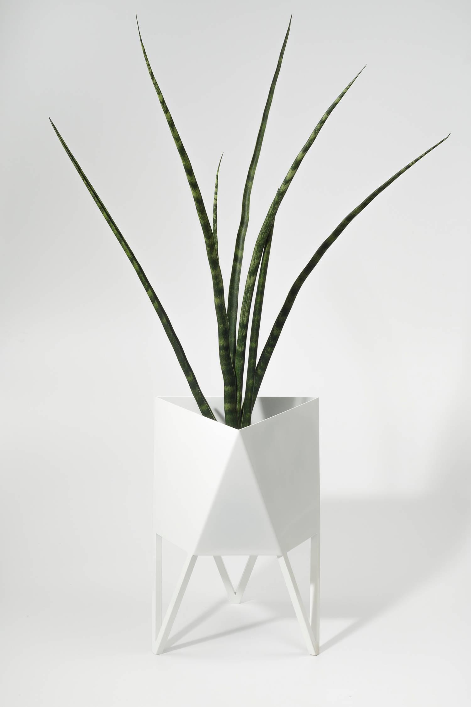 Introducing Force/Collide's signature planter in glossy white. Using a seamless brake-forming technique, one sheet of steel is wrapped into a unique geometric pattern that's triangular at the top and hexagonal at the base. Three V-shaped legs
