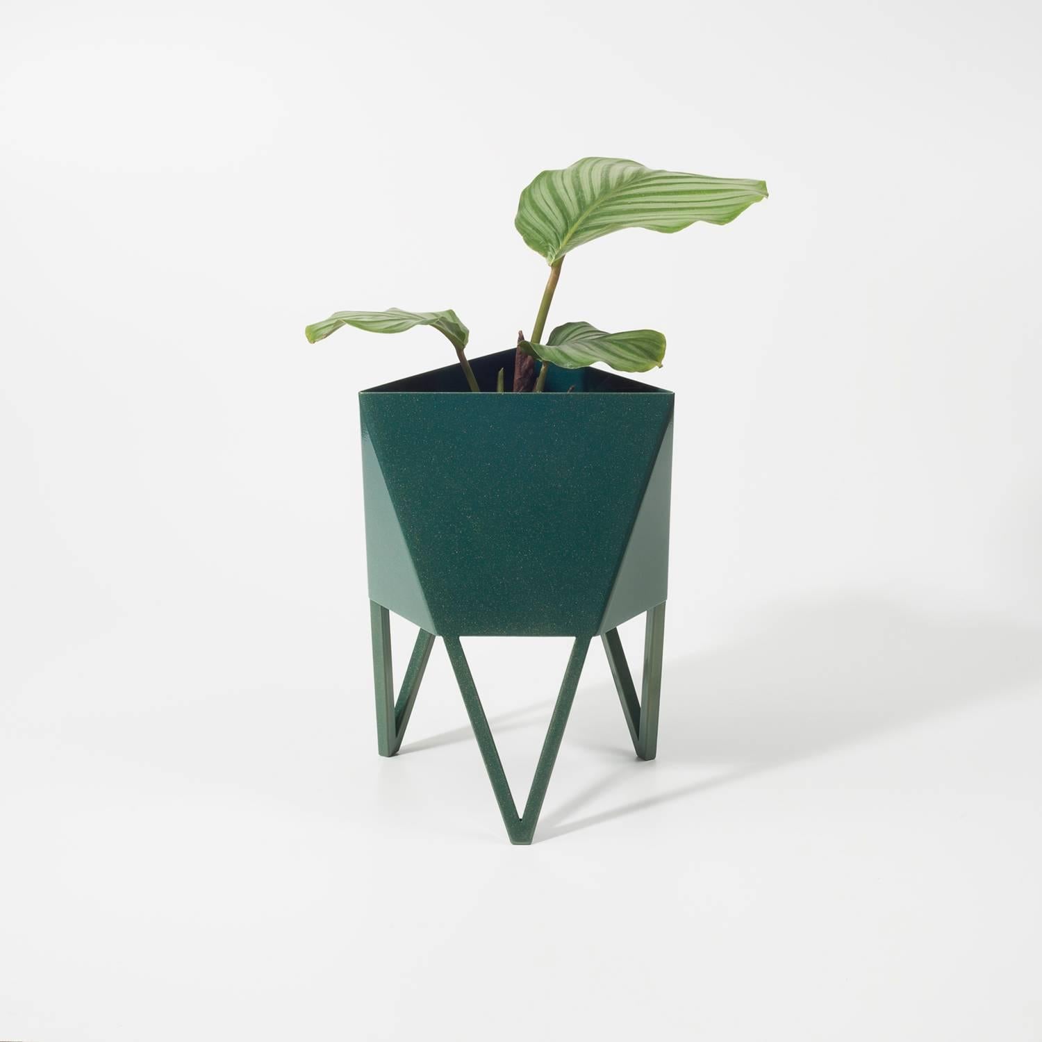 Introducing Force/Collide's signature planter in subeam bluegreen. Using a seamless brake-forming technique, one sheet of steel is wrapped into a unique geometric pattern that's triangular at the top and hexagonal at the base. Three V-shaped legs