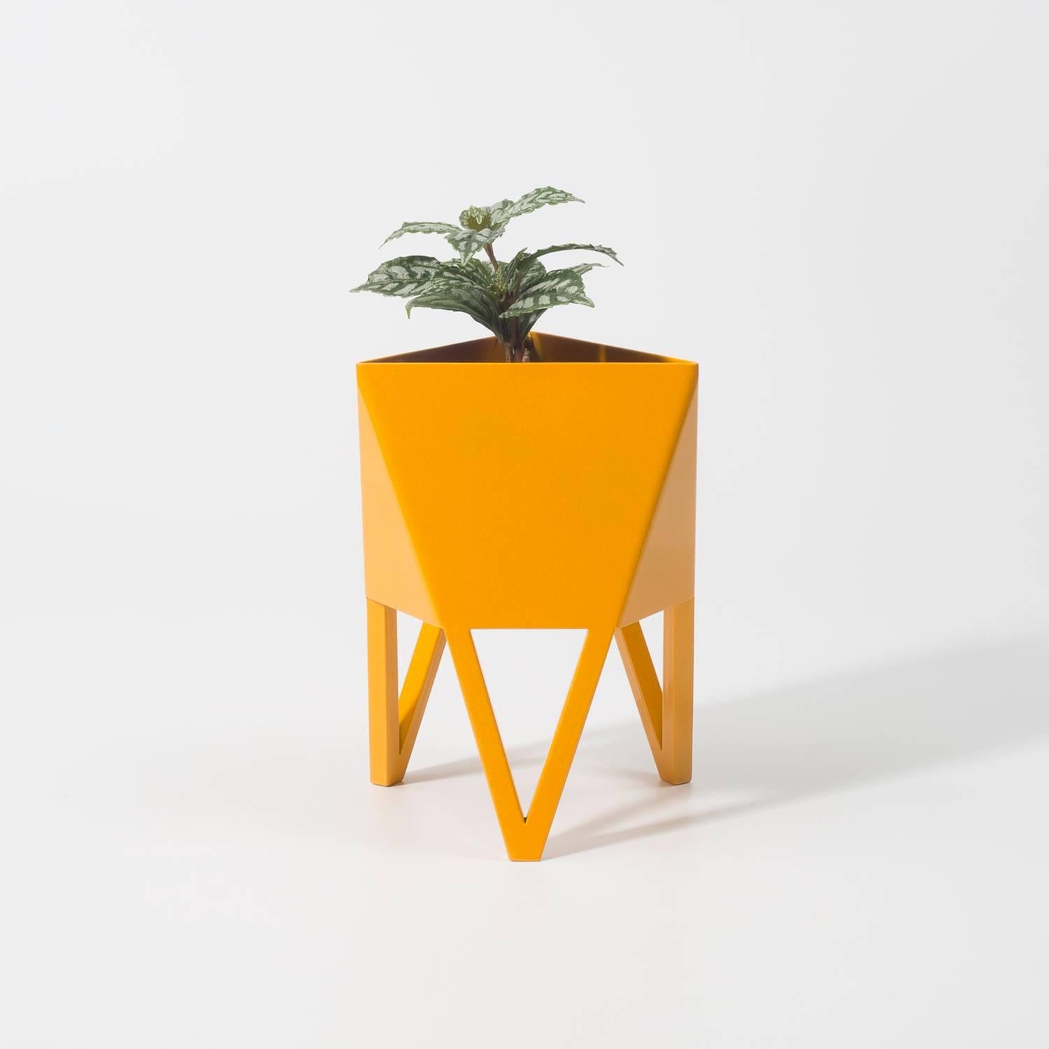Introducing Force/Collide's signature planter in sunbeam daffodil yellow. Using a seamless brake-forming technique, one sheet of steel is wrapped into a unique geometric pattern that's triangular at the top and hexagonal at the base. Three V-shaped