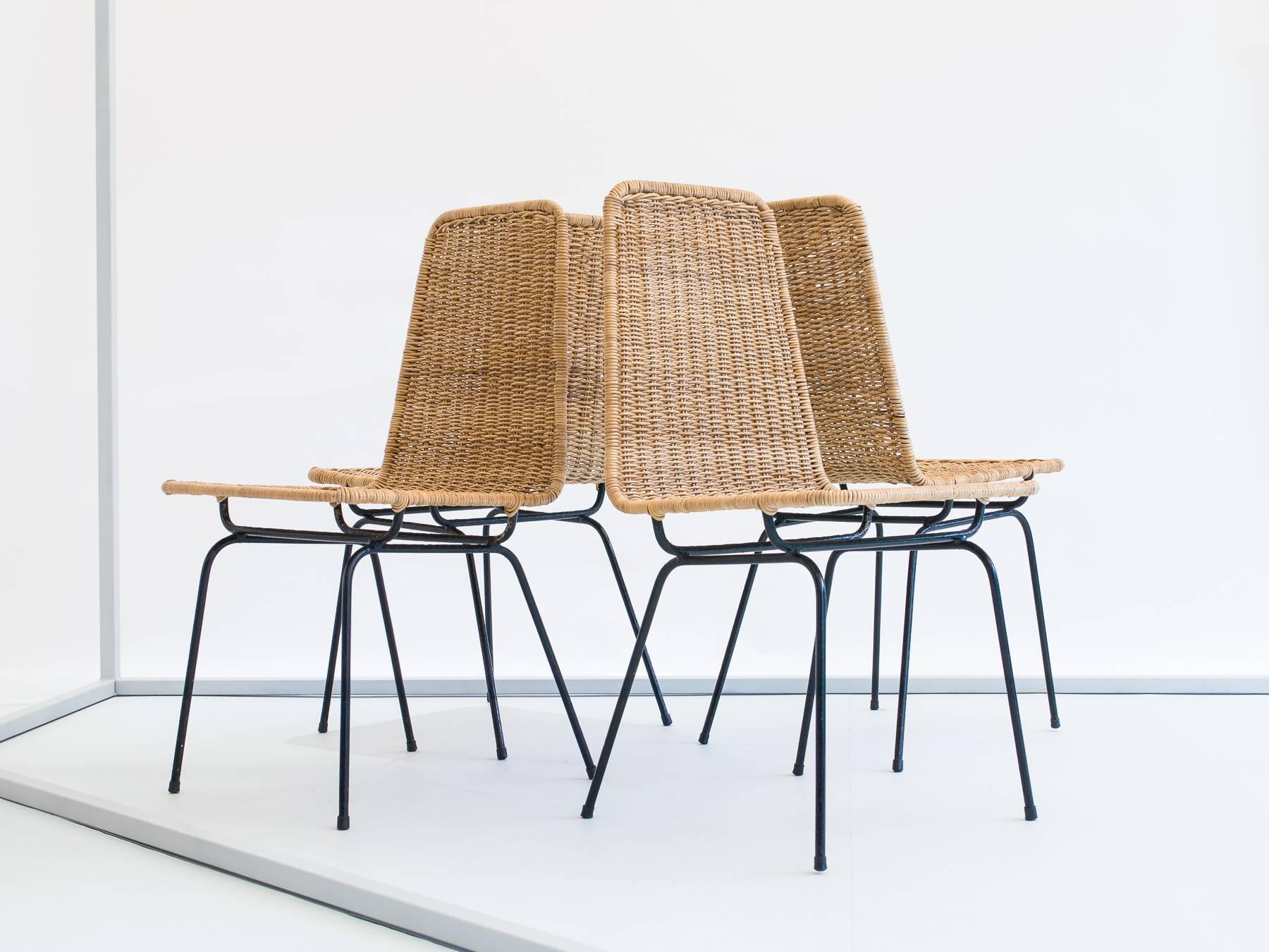 Classic wrought iron chairs designed by Hauner and Eisler, produced by Forma S/A. Original reed was lost to termites, so the reed has been fully replaced with natural reed from the Amazon Jungle.