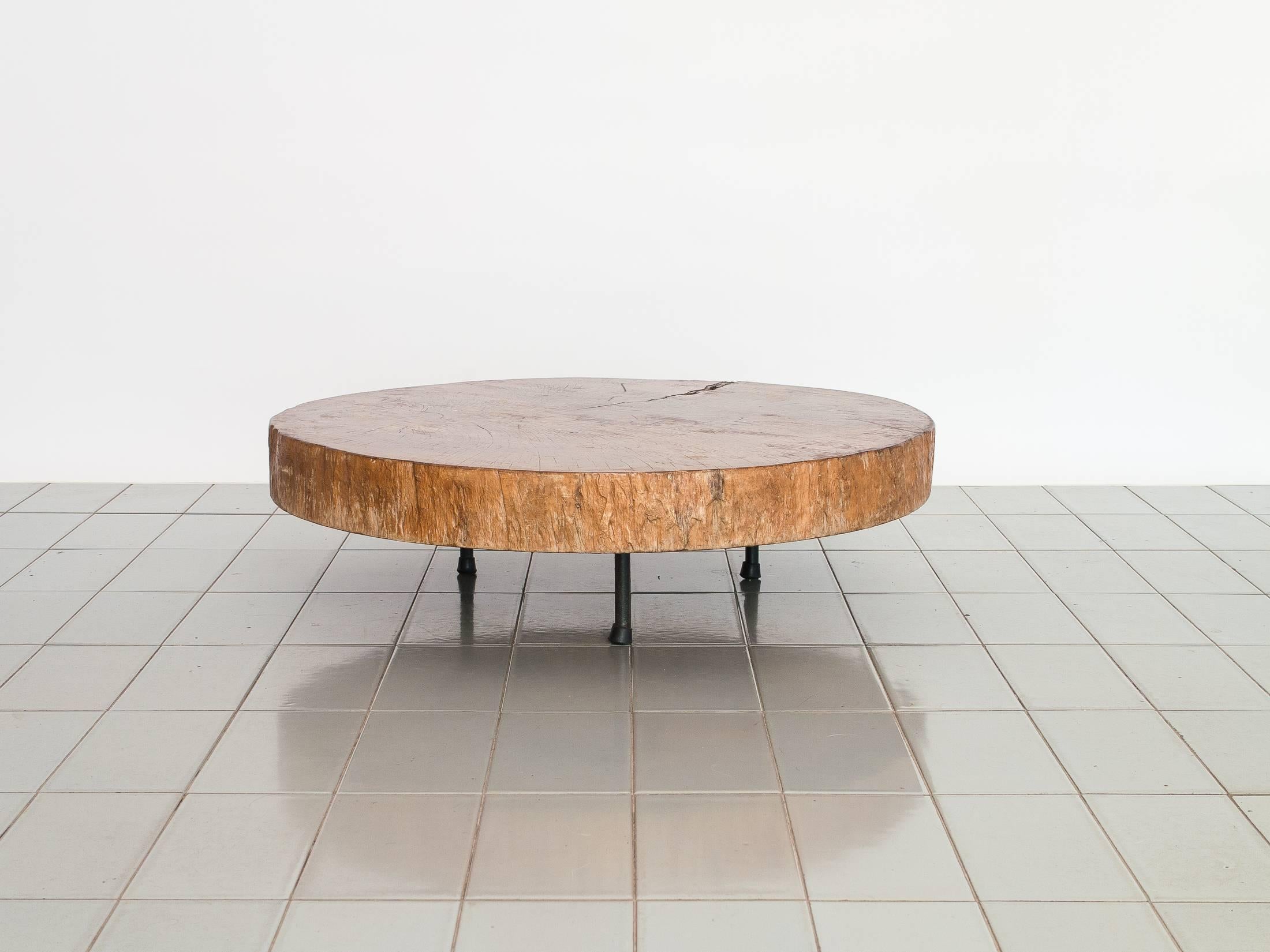 This solid Pequi Pedra top was acquired with a wooden base that was affected by termites. Its perfect round top now stands over old Unilabor iron feet. Live edges. The crack is stabile.