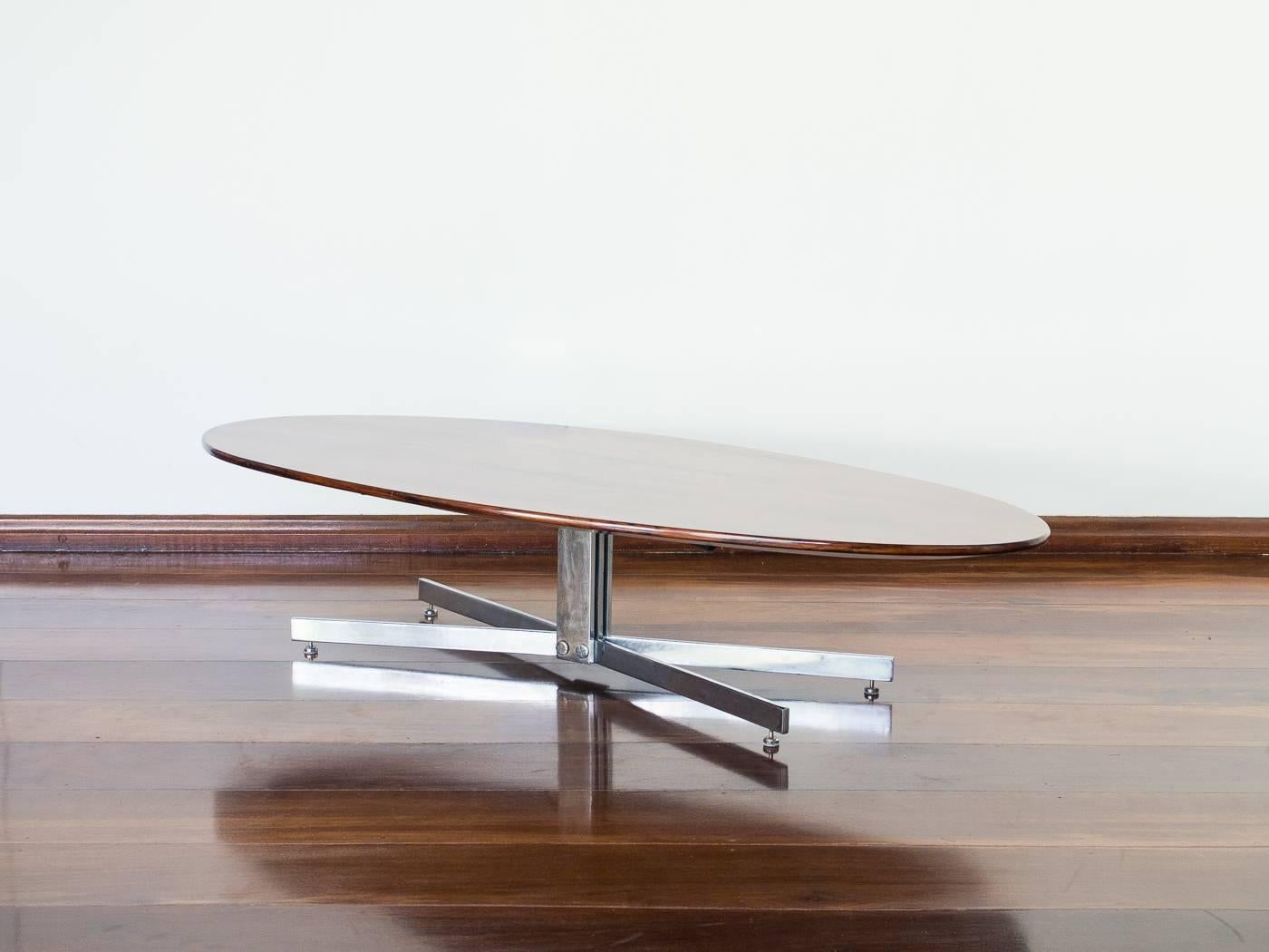 Beautiful table, rare model coming out of the spoils of government buildings in Brasília. Chrome legs lead to a beautiful beveled top, with solid rosewood edges and amazing light toned rosewood veneer on top.