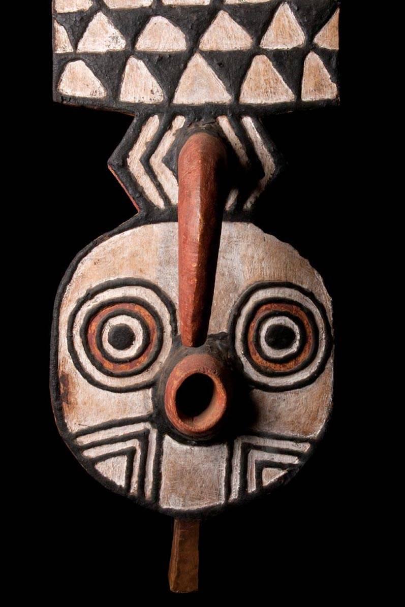 Very important “Nwantamtay” dance African mask, consisting of three sections: The upper in plain rectangular shape surmounted by a crescent shape moon, the middle with beautiful geometric triangles in black bitumen and white kaolin, surrounding a