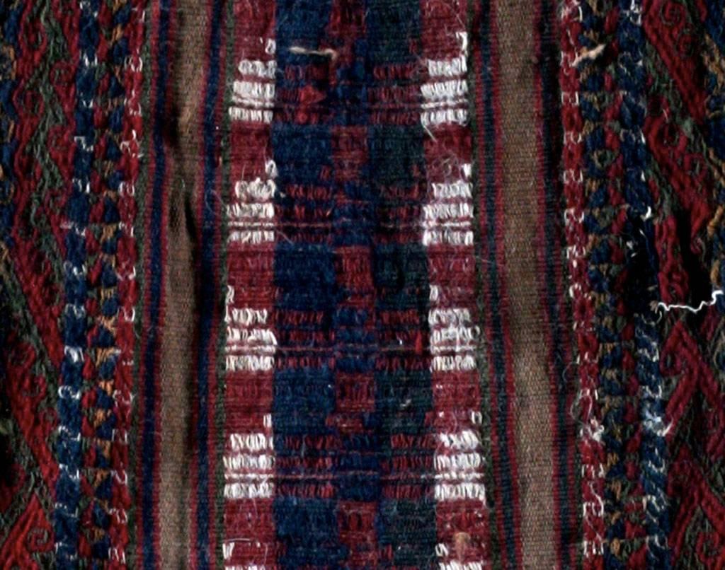 Inca multi-color Medicine Man or Shaman’s coca leaf bag. This rectangular sac is adorned with geometric decoration in vertical blue and red lines and ends in hanging fringe with blue and white tassels.

Mounted in a wood frame, stabilized and
