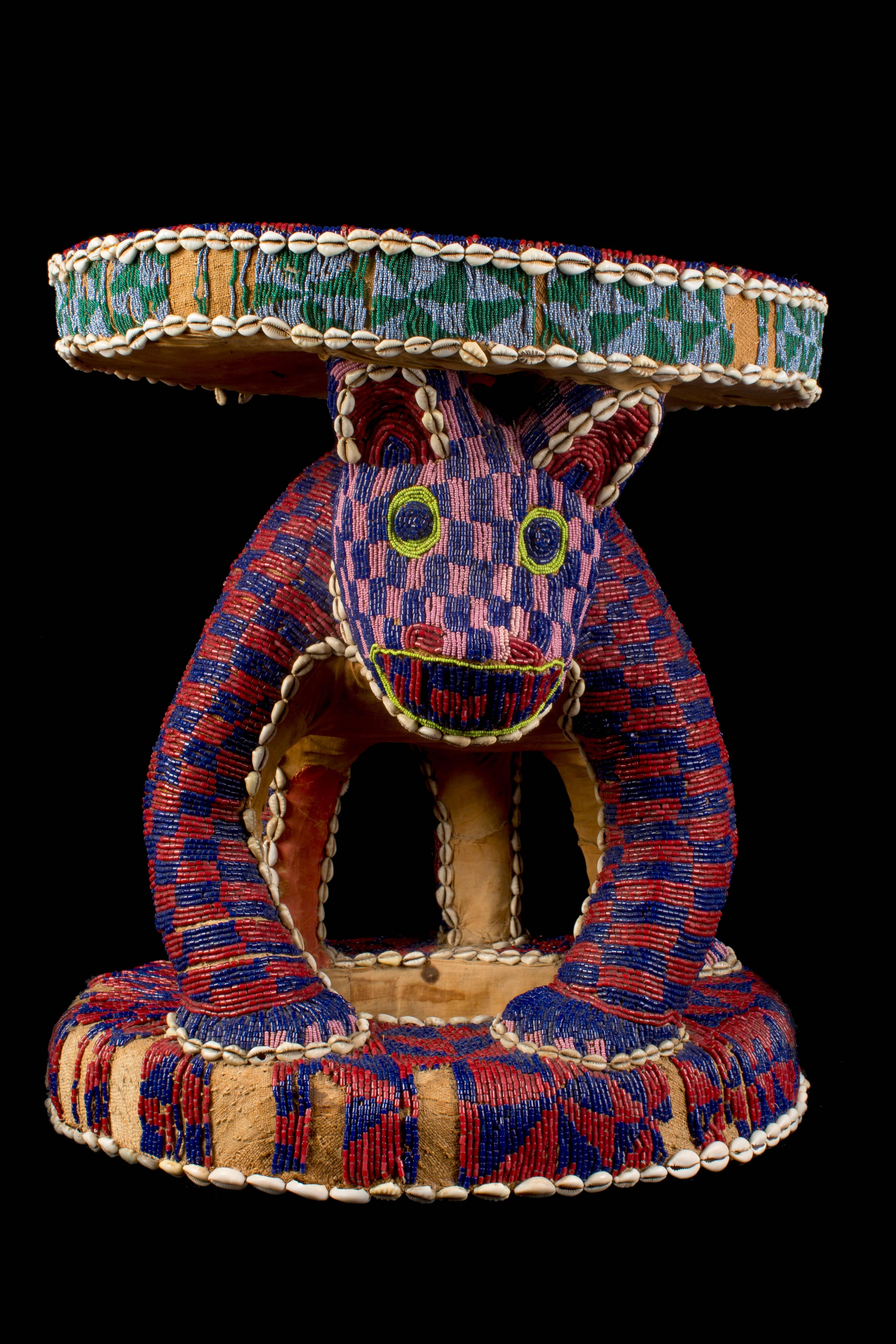 Bamileke throne made with wood, coated with jute, embroidered with polychrome glass beads, cowrie snails, embroidery with glass beads that are missing in some areas. In the Grassfield Kingdoms the leopard was looked upon as a symbol of royal power