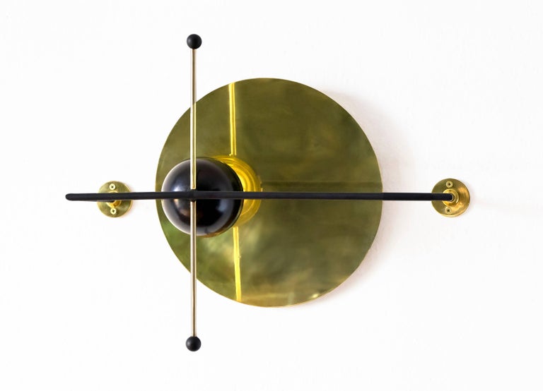 Mexican design bureau Nomade Atelier pays homage to Laszlo Moholy-Nagy's geometrical and cosmic monograms and prints- from color scheme to construction. Mounted on a wall through three contact points, the sconce's warm and diffuse LED light emanates