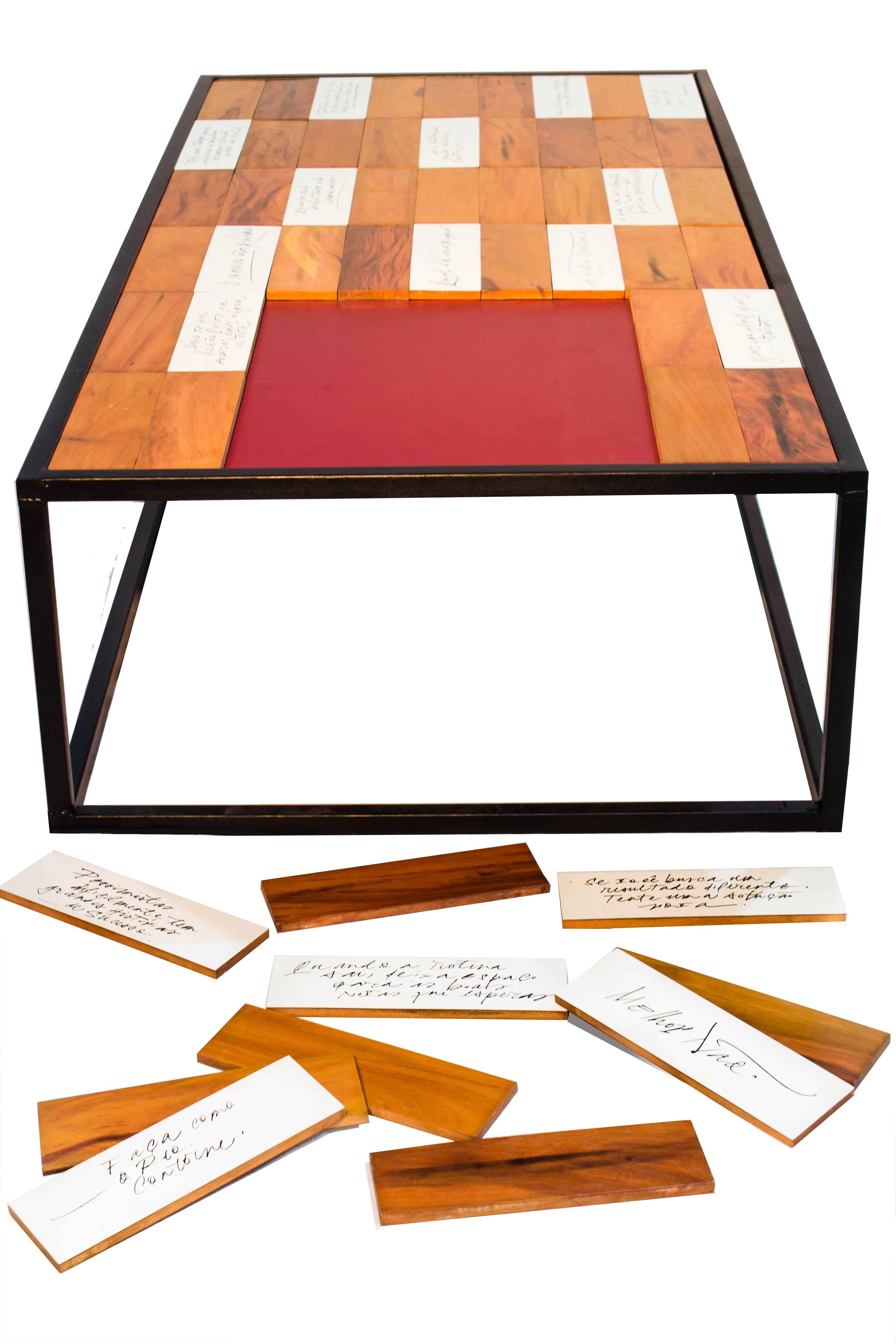 Lucky table is a coffee table topped with old Peroba wood parquet, recovered from demolitions with the back of each engraved with handwriting by a calligrapher invited. The inspiration comes from the Chinese fortune cookie, bringing a different
