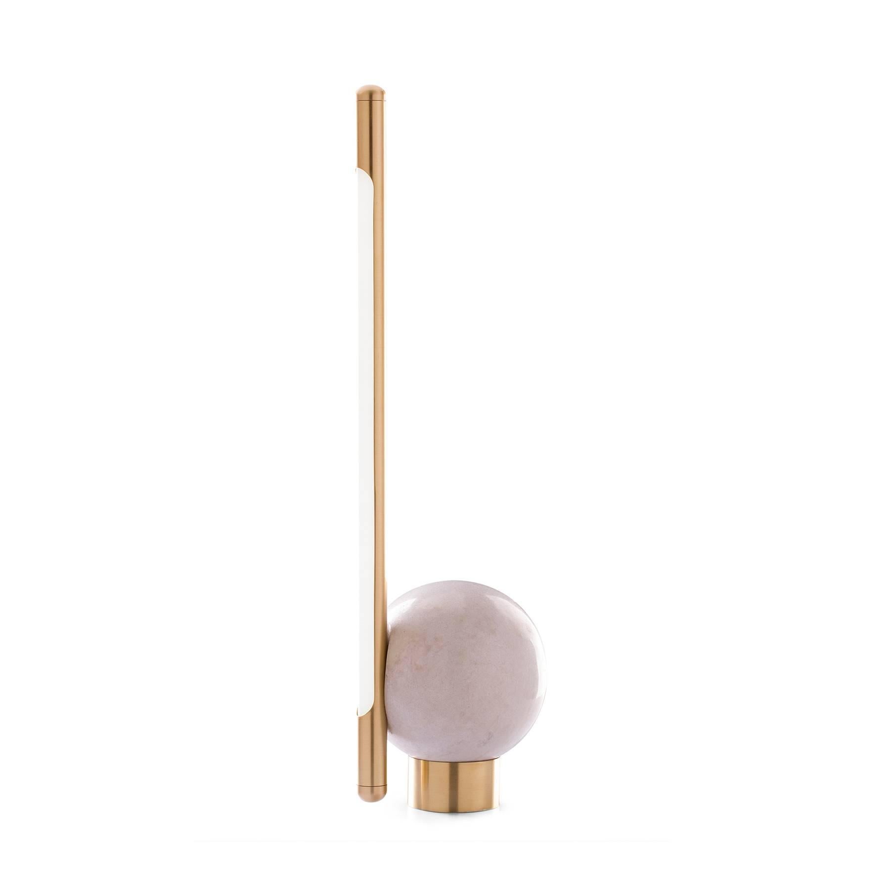 The Bubble is a table lamp designed to be interactive with the user. Executed with a sphere carved by hand from a block of marble found in the state of Espirito Santo, Brazil, has a brushed brass rod with a LED lamp inside. The adjustment is made