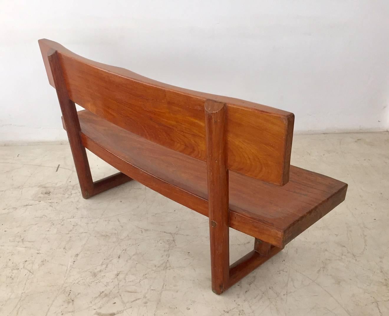 Brazilian modern bench, design and manufactured by Zanine Caldas, this curved bench is a masterpiece of Zanine Caldas, very comfortable with the seats carved in the wood. It was manufactured to a residence projected by the designer in Brasilia,