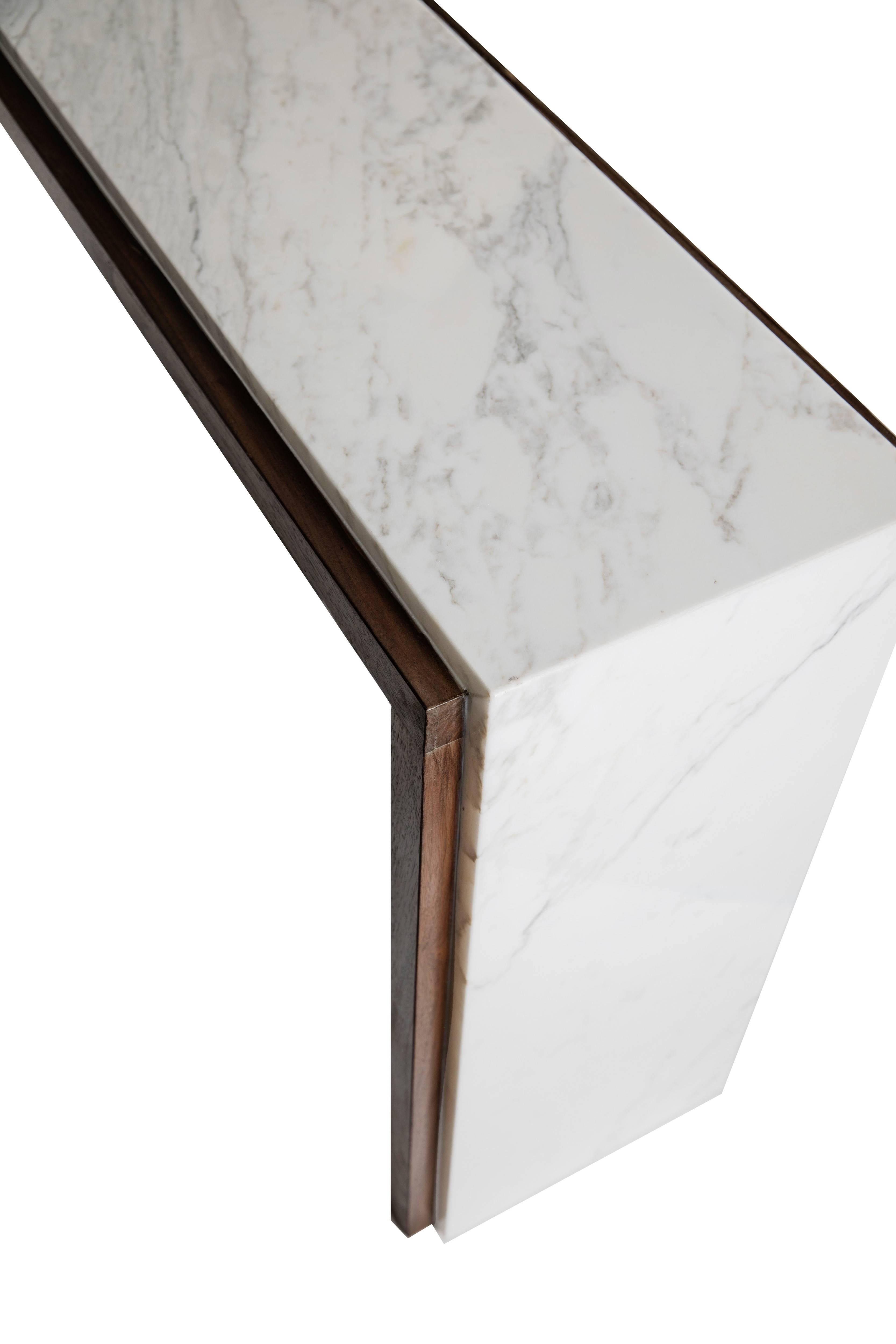 The modern Calista console elevates the Classic runway Silhouette. With your choice of exotic marble, it makes for an amazing statement piece. We have also used it as a desk, a buffet and a sofa table. Place two of our Coco ottomans underneath for