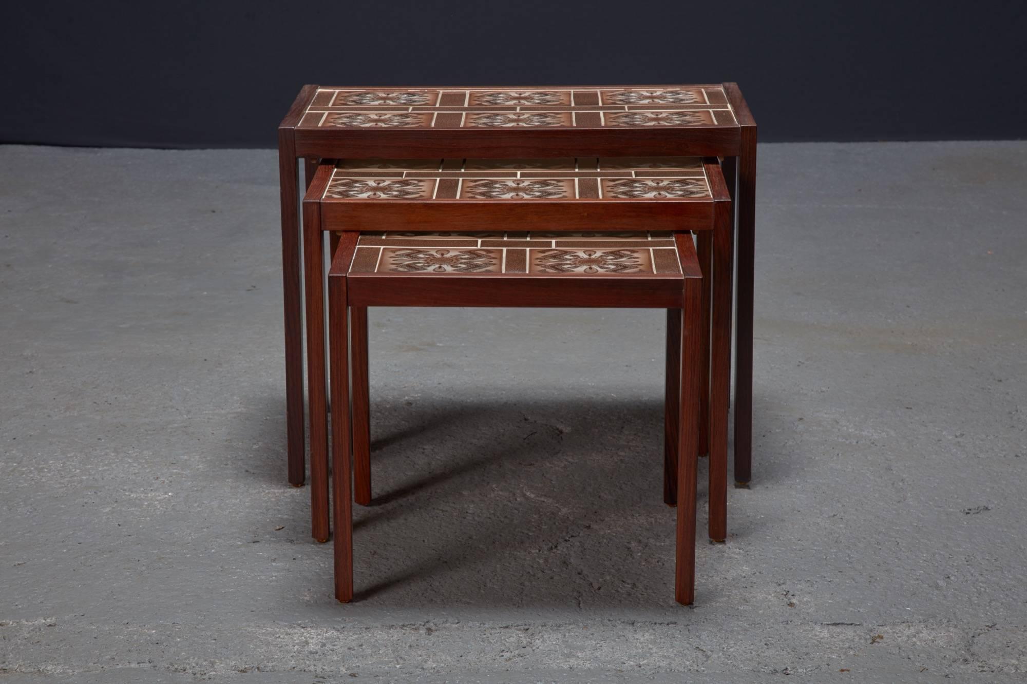 Set of three rosewood and tile Danish modern nesting tables. 

Largest: 25.25