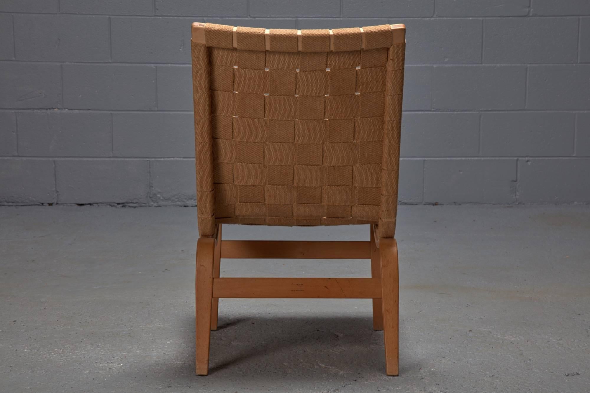 Swedish designer Bruno Mathsson created this particular Eva model with a low back and no arm rests. The birch frame supports a woven linen seat and back.