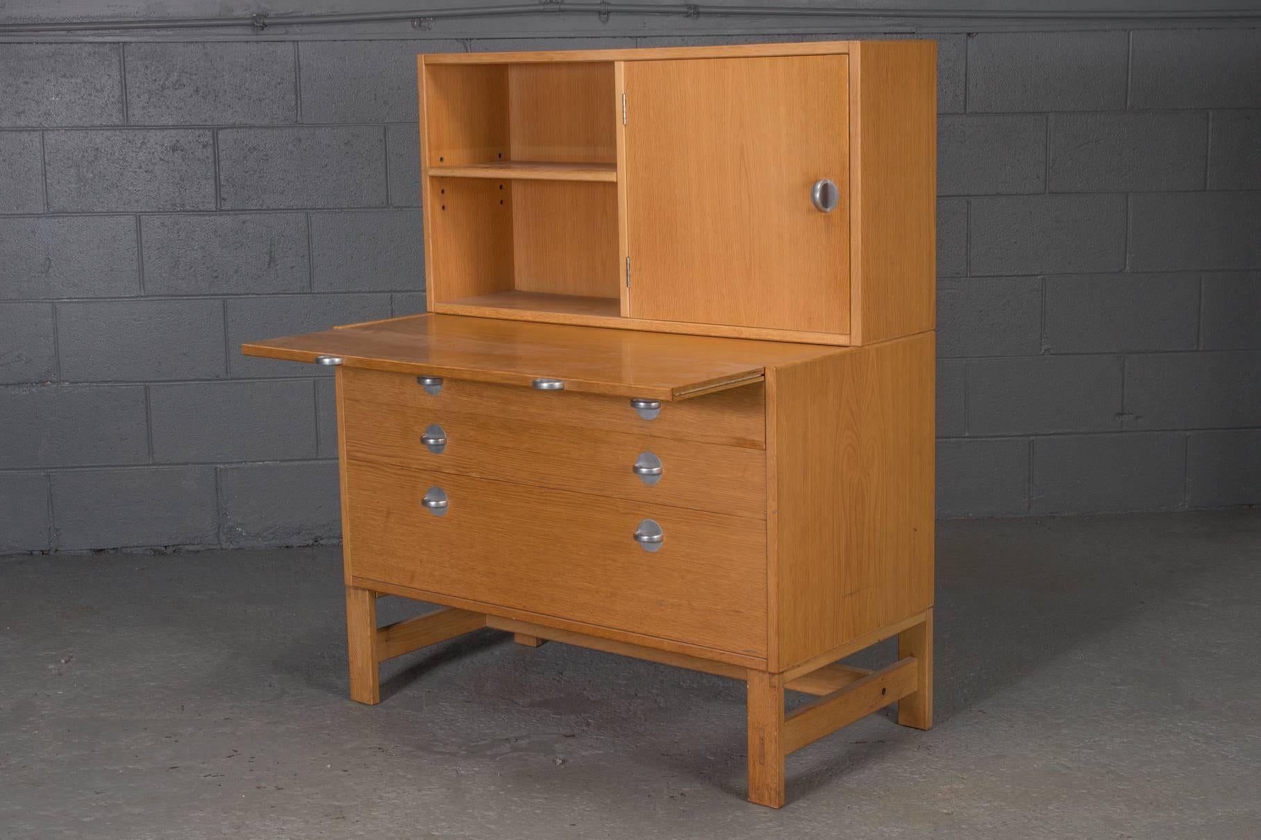 Oak bookcase unit and chest with stainless steel handles.