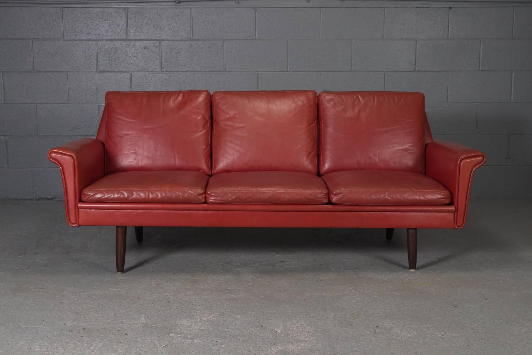 Red leather Danish modern sofa. 