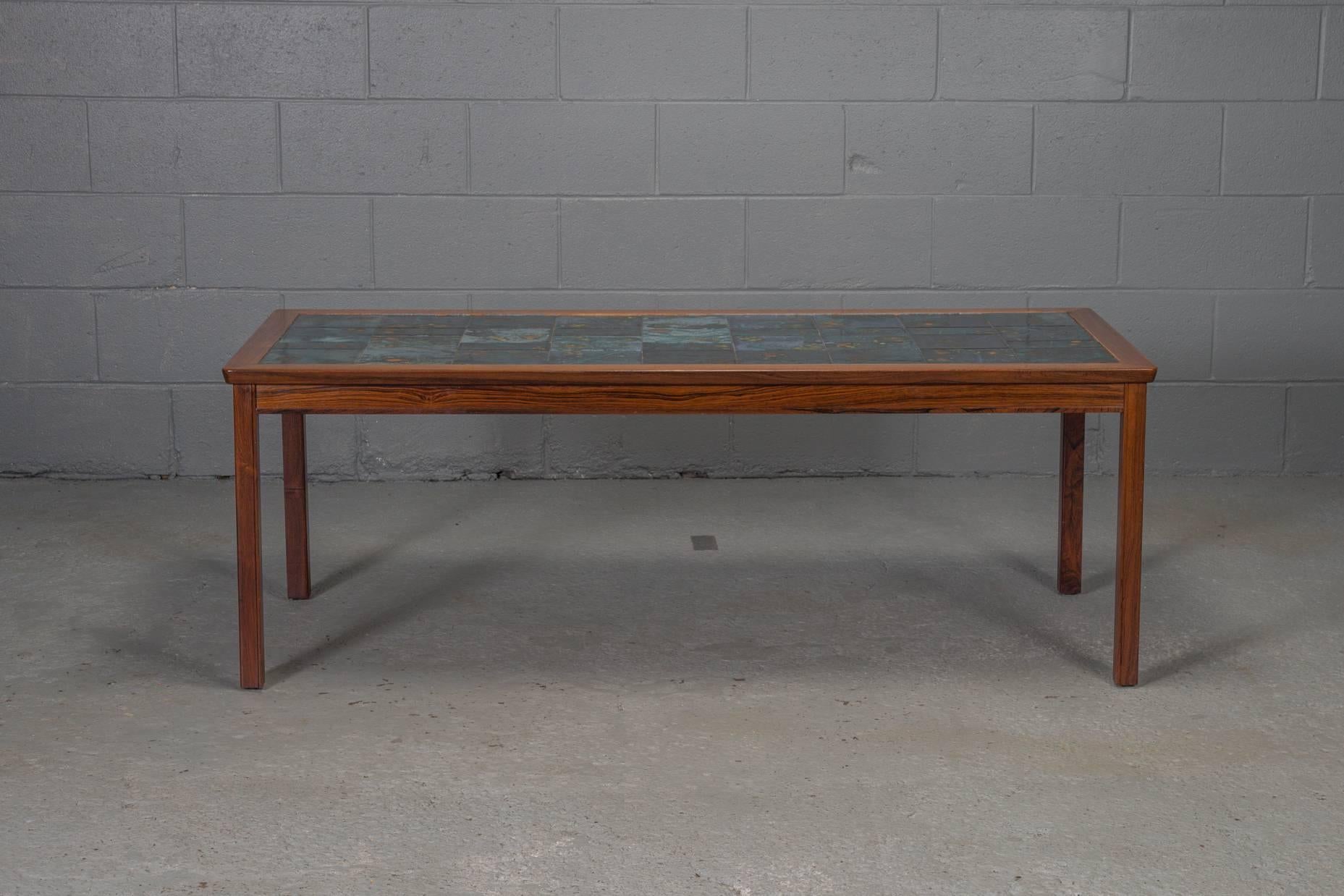 Rosewood and tile coffee table.