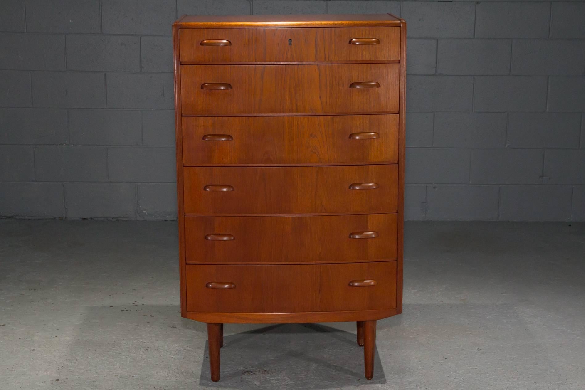 Six-Drawer Danish Modern Teak Dresser with curved pulls. Top drawer with lock, key not included. Stamped on back. 