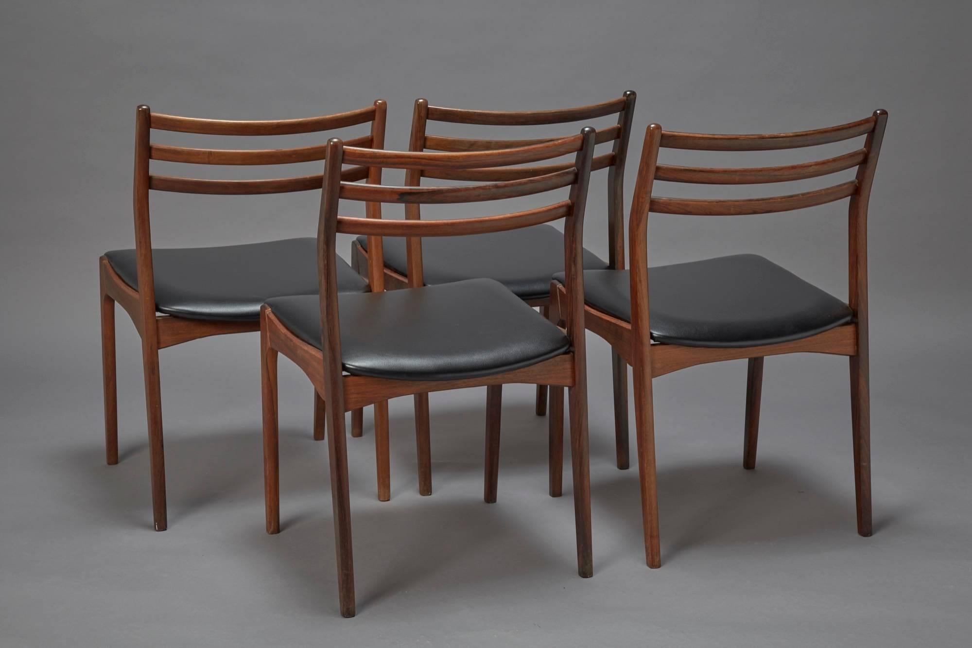 A set of four rosewood dining chairs attributed to Niels Otto Møller similar to his model 78 design, Denmark. Reupholstered in black faux leather, excellent condition.
  