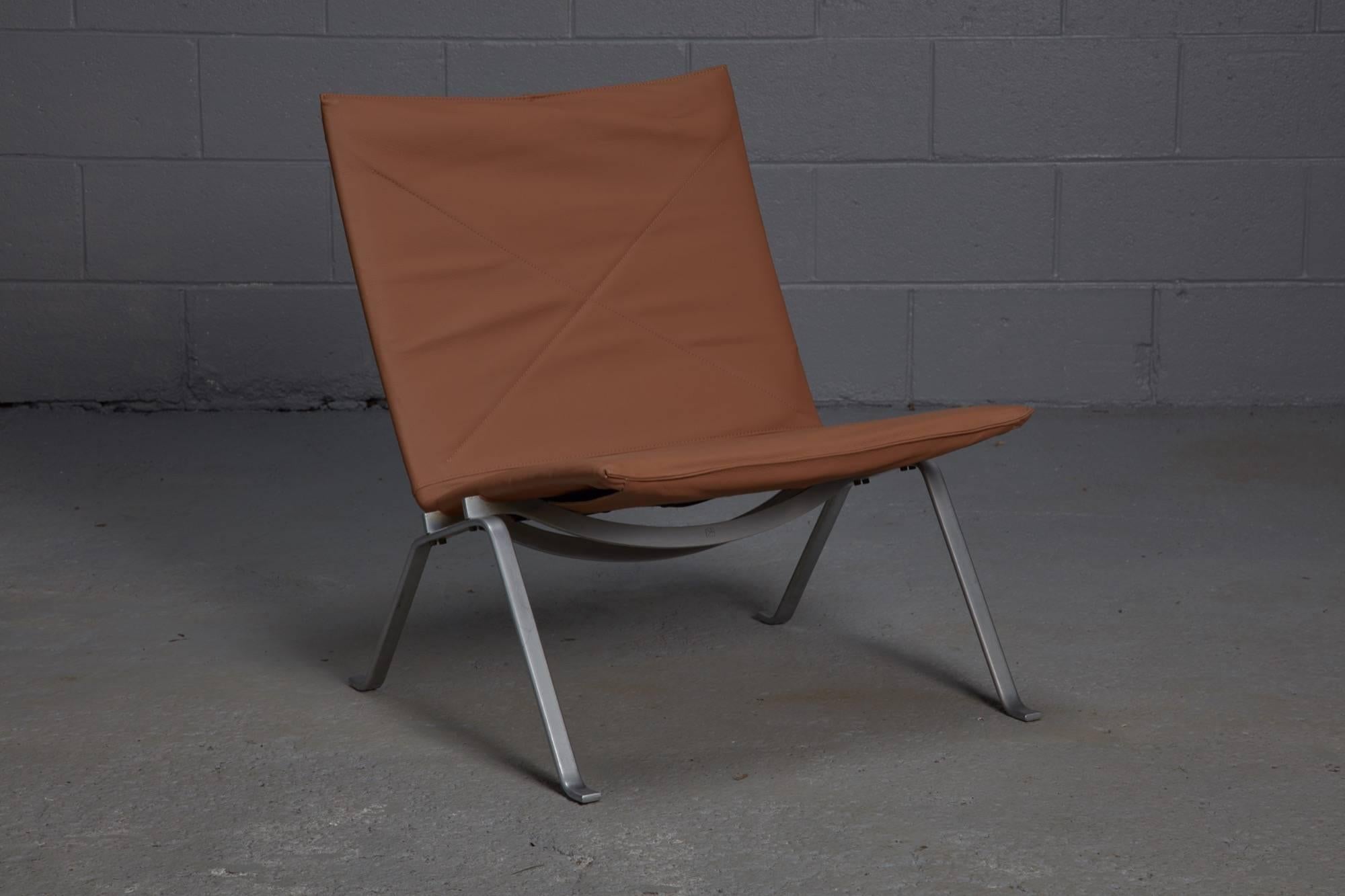 Designed by Poul Kjaerholm for his friend and manufacturer E. Kold Christiensen, the PK22 is made from brown leather and stainless steel. While many of Kjaerholm's contemporaries primarily used wood in their furniture designs, Kjaerholm favored