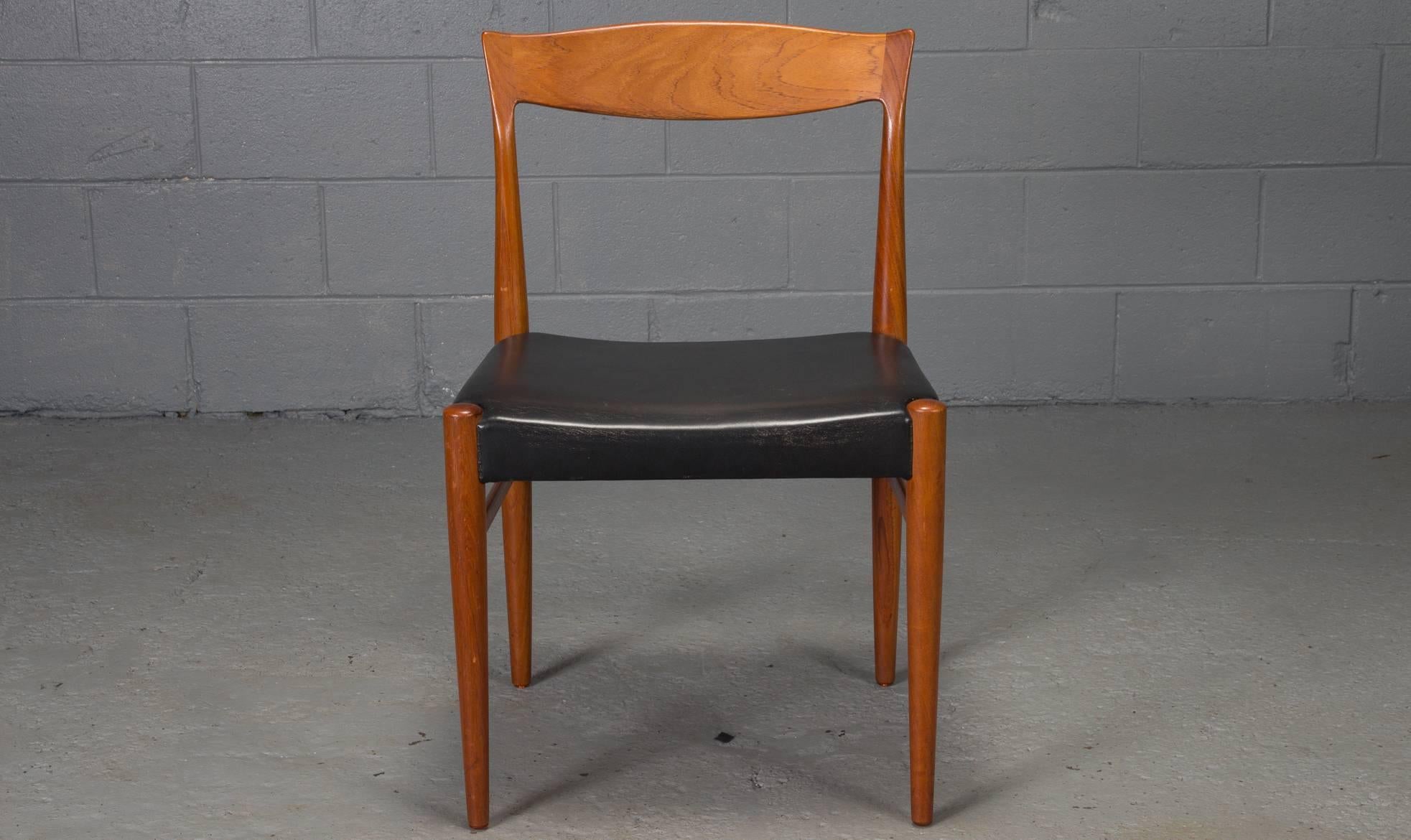 Set of six teak dining chairs by Henning Kjaernulf.					