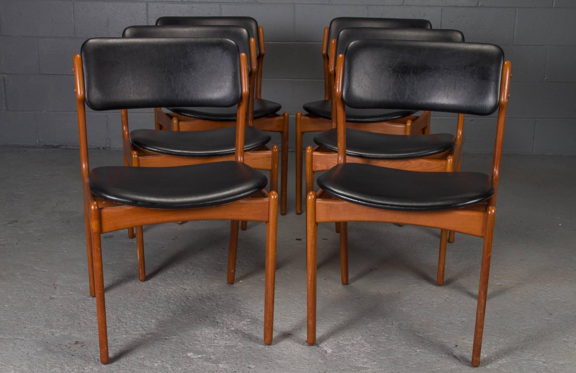 Designed in Denmark by Erik Buch for O.D. Mobler, these chairs feature a teak frame with leather seat and back, and are sold as a set of six.
