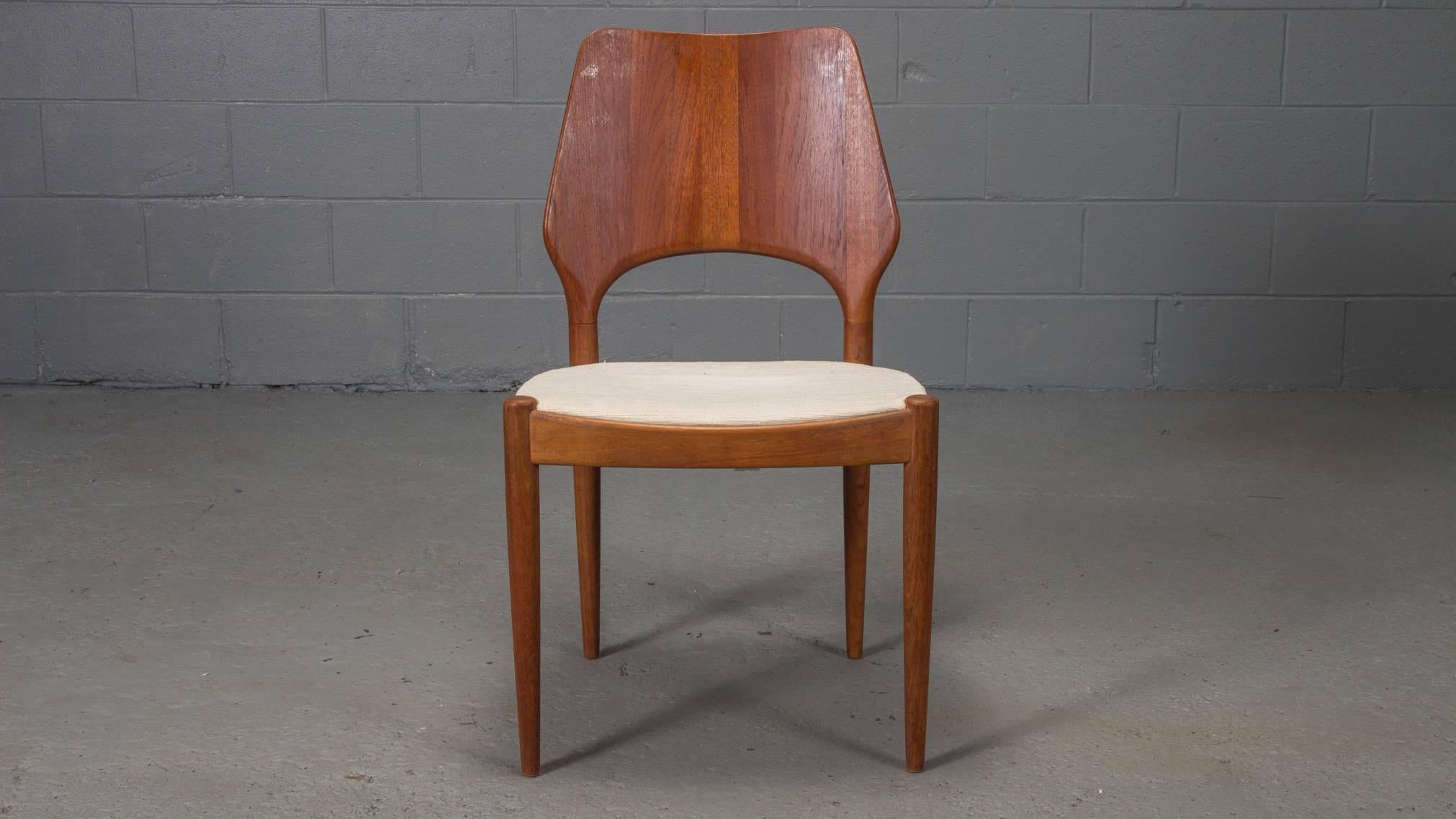 Set of four Danish modern solid teak finback dining chairs with metal Danish Control label, 1950s.