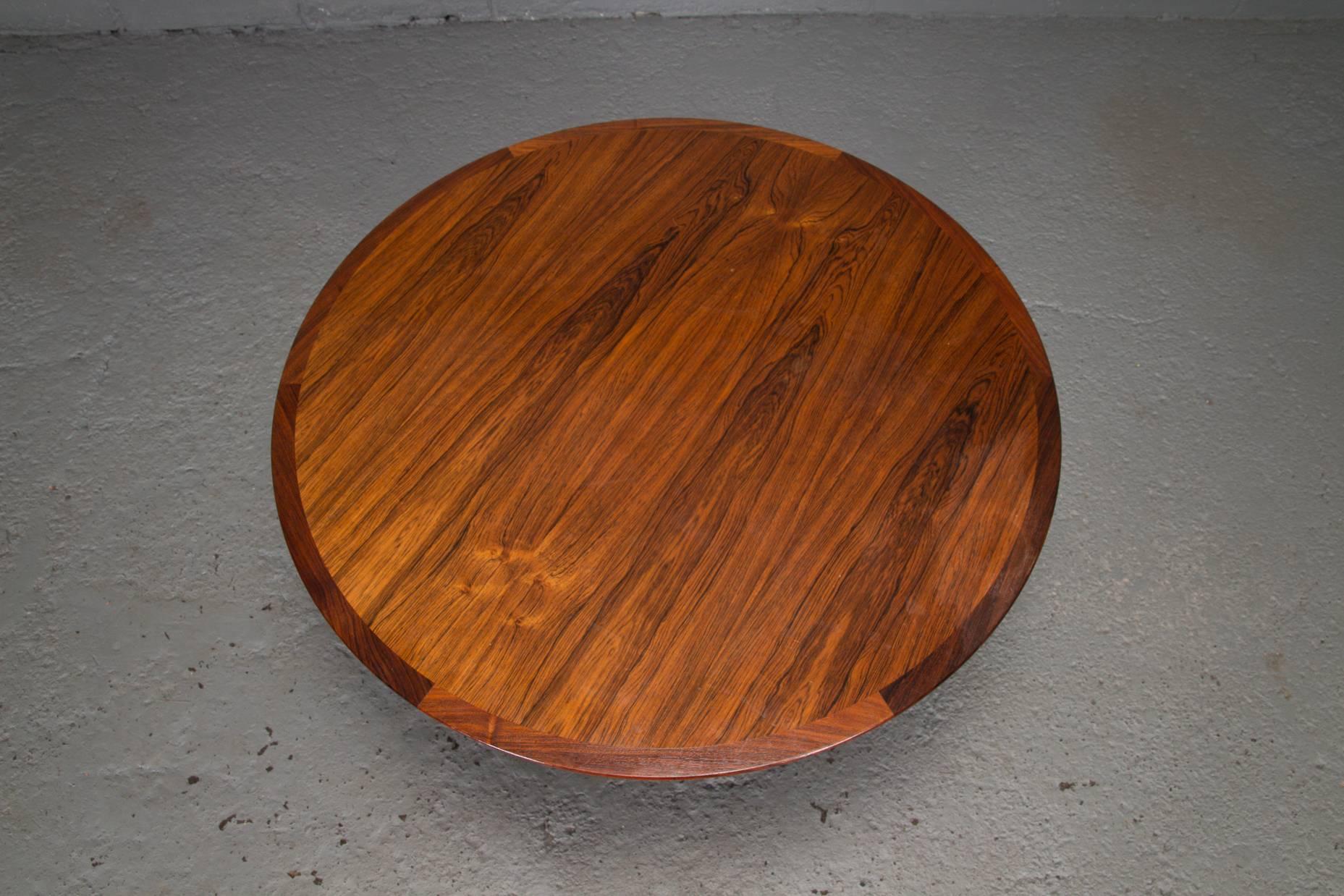 Round rosewood and chrome pedestal base coffee table. Bevelled edge.