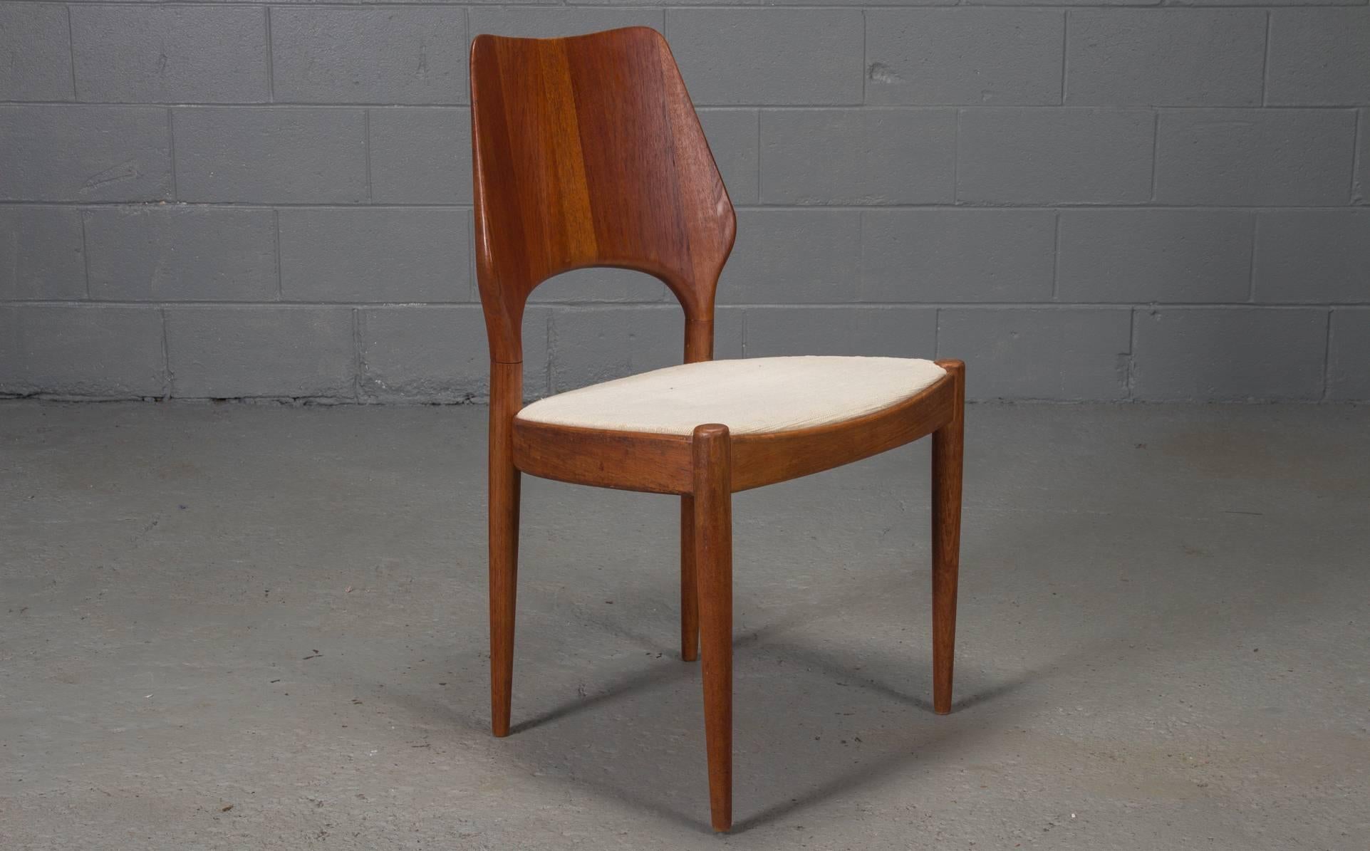 Set of four Danish modern solid teak finback dining chairs with metal Danish control label, 1950s.