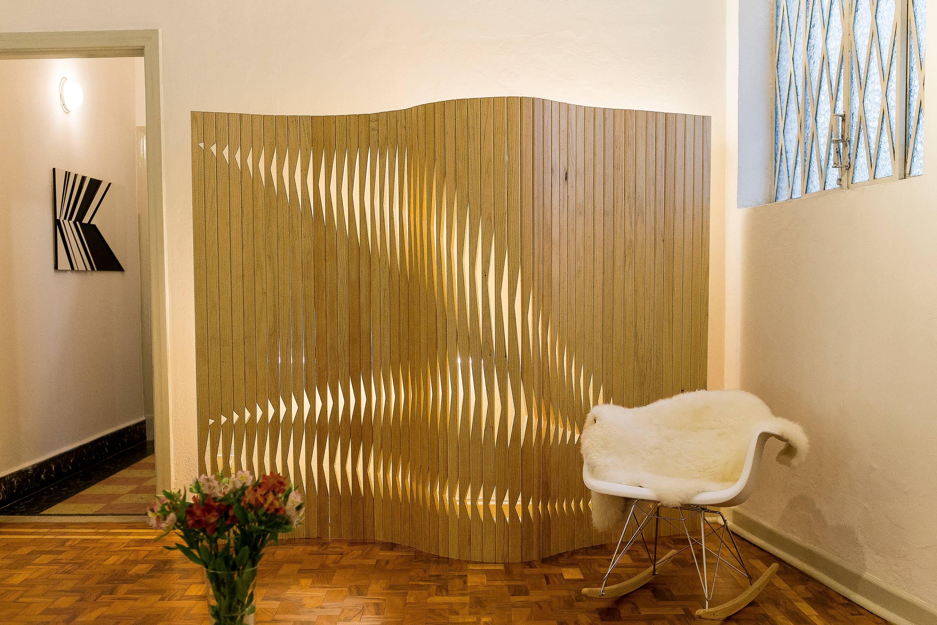 The 'V.az' is a wooden partition screen that transmits the idea of fluidity. Due to its soft openings and the idea of movement these openings transmit, it is a poetic and interactive furniture piece. It was designed on computer and inspired on