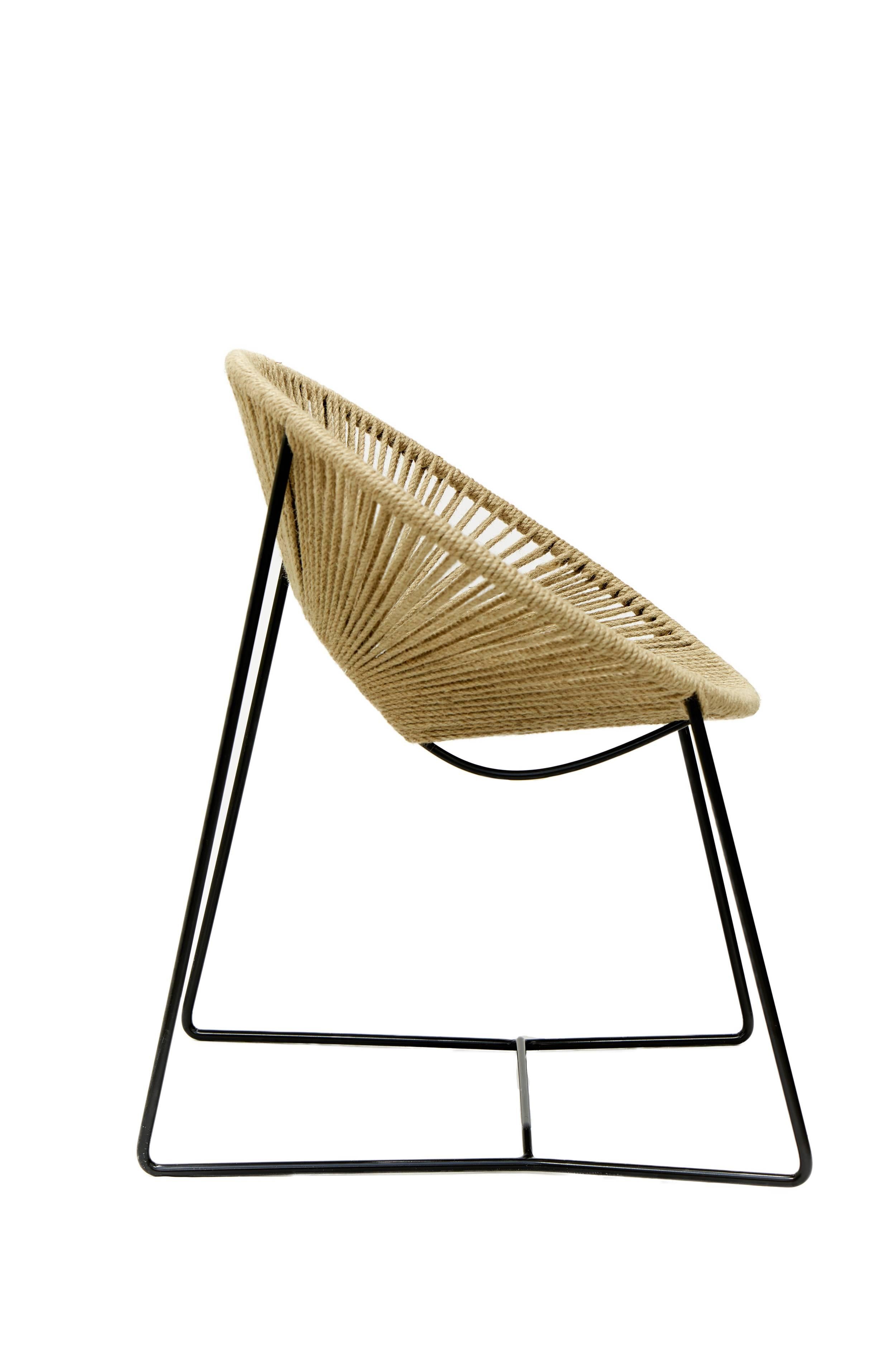 This handwoven tropical Cali dining chair is a unique creation by Leon Leon Design from Mexico City, a modern version of the famous Acapulco chair. Its weaving material is made of organic vegetal fiber handcrafted in Yucatan region
