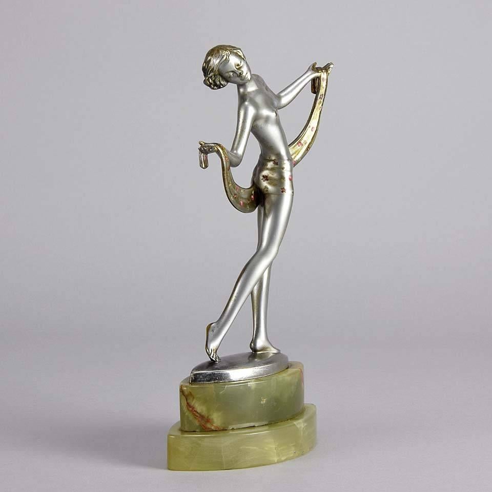 An elegant Art Deco bronze figure of a young beauty in a dancing pose wearing a shawl around her midriff decorated with enamelled floral motifs by in house artist Crejo. The bronze with excellent cold painted colour, with lightly worn surface and
