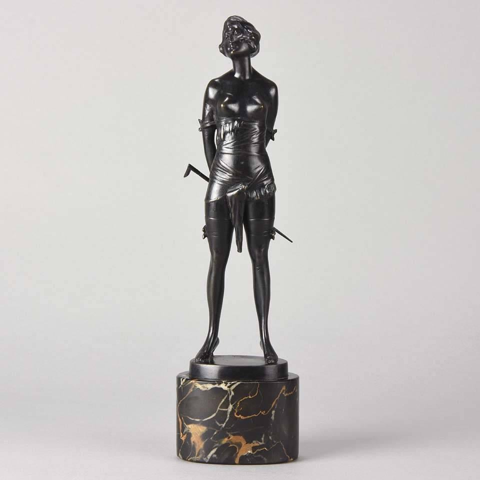 As part of our sculpture collection we are delighted to offer this sensuous and highly erotic Art Deco cold painted bronze figure of a seductively dressed young lady holding a riding crop behind her back standing in a domineering pose and wearing a