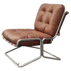 Sillón lounge de piel marrón y tubos de acero cromado, Italia, década de 1970