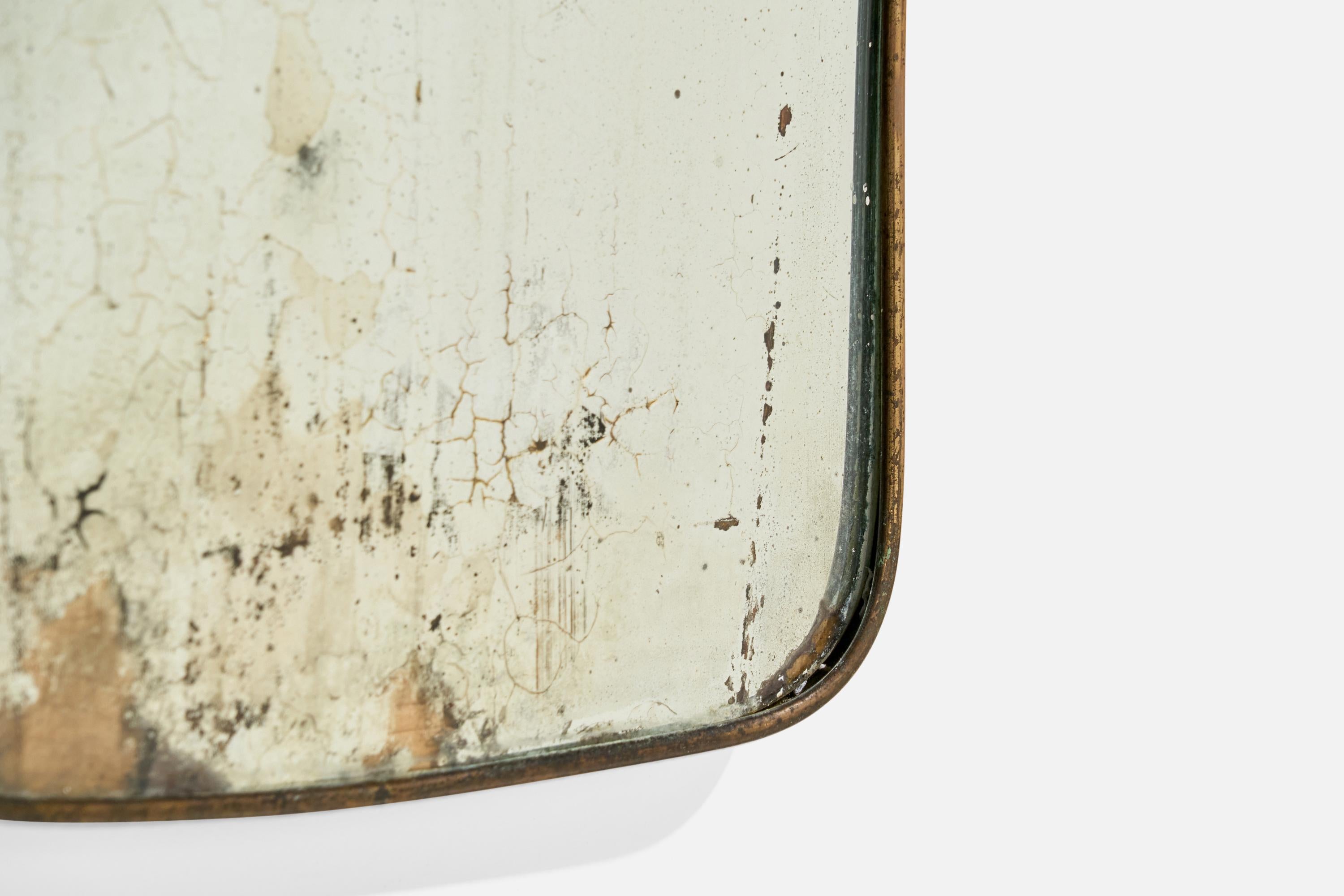 A brass wall mirror designed and produced in Italy, 1940s.