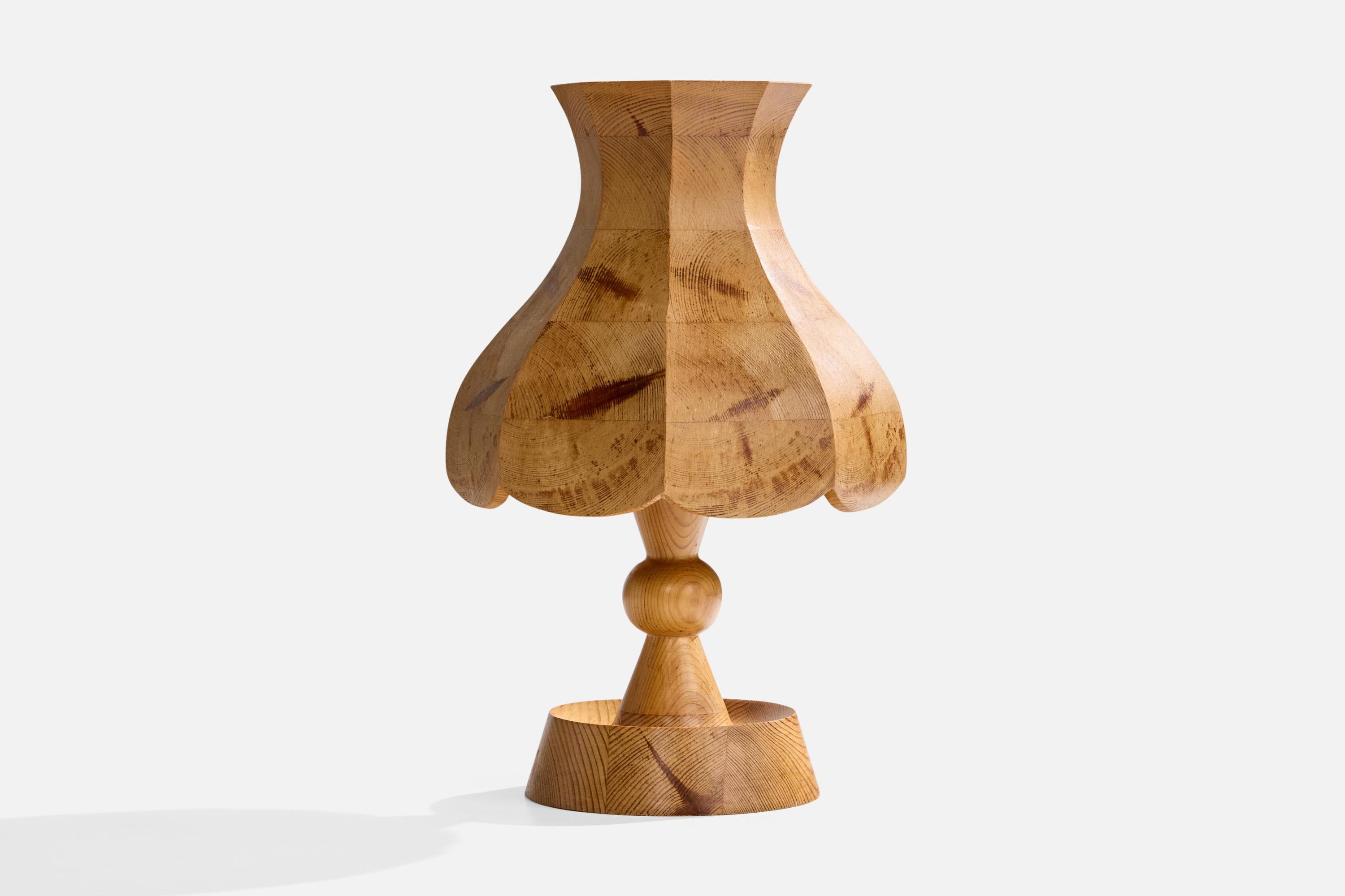 A pine table lamp designed and produced in Sweden, c. 1970s.

Wear to wood consistent with age and use

Dimensions of Lamp (inches): 12.5