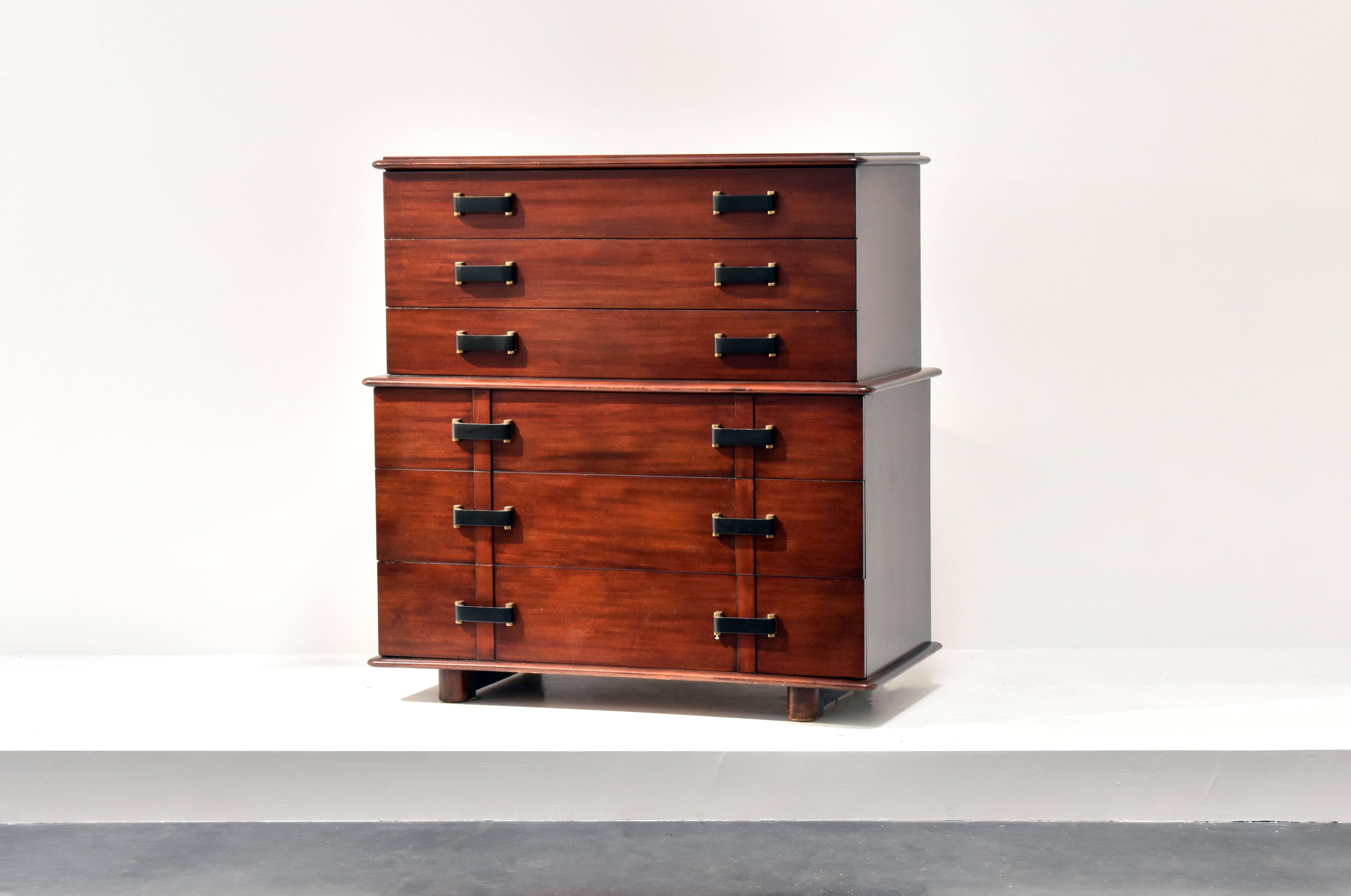 A beautiful and practical tall six-drawer dresser that bears the iconic design of Austrian modernist designer/architect Paul Frankl. The present example is a rare one with black wooden grips.

 Designed in 1950 for Johnson Furniture Company. The