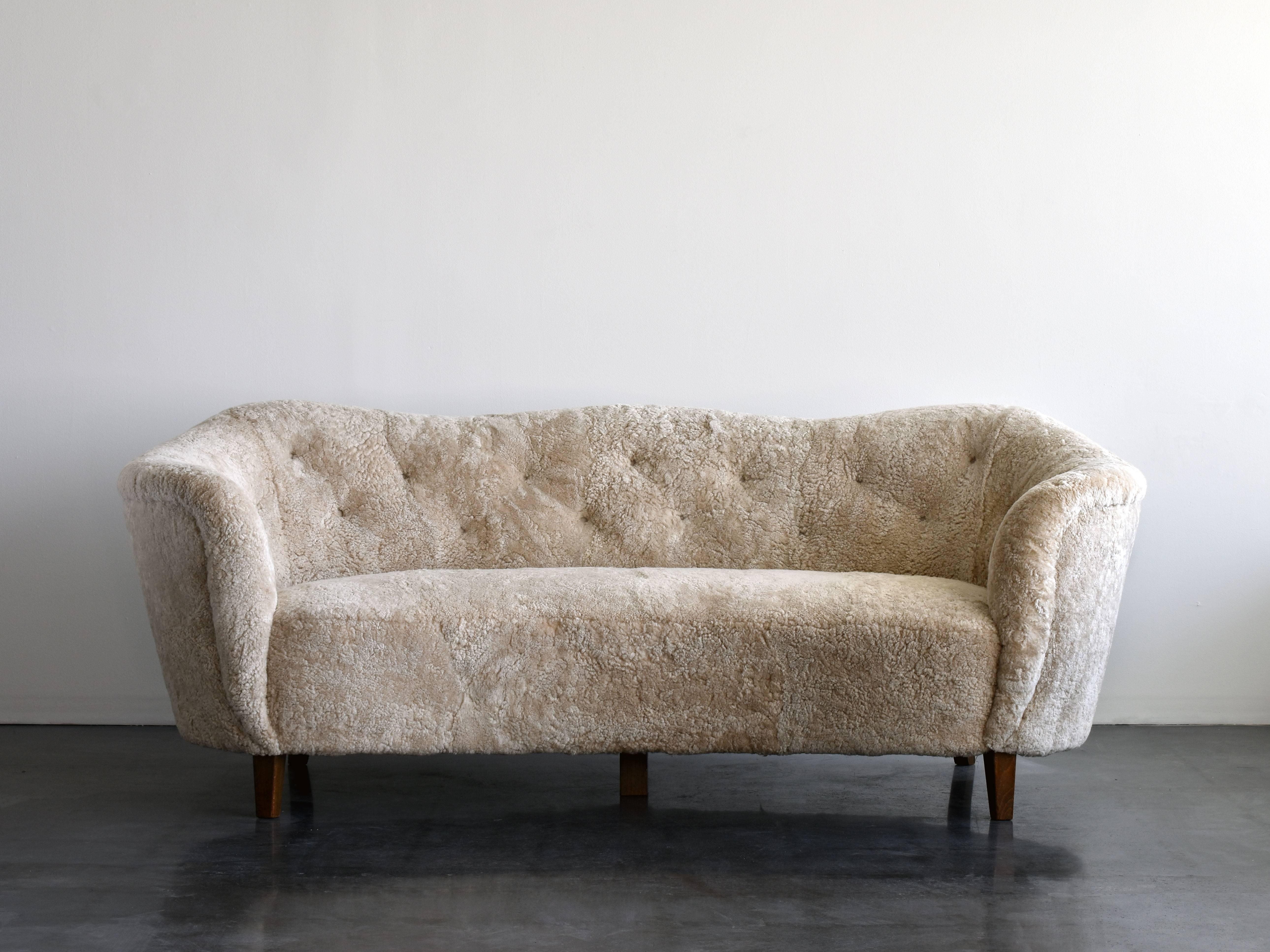 An early Danish modernist sofa with an organic form similar to works by important architects such as Viggo Boesen, Philip Arctander, Peder Moos and Flemming and Mogens Lassen. Presumably manufactured by N,C. Christophersen, circa 1949, Denmark.

 