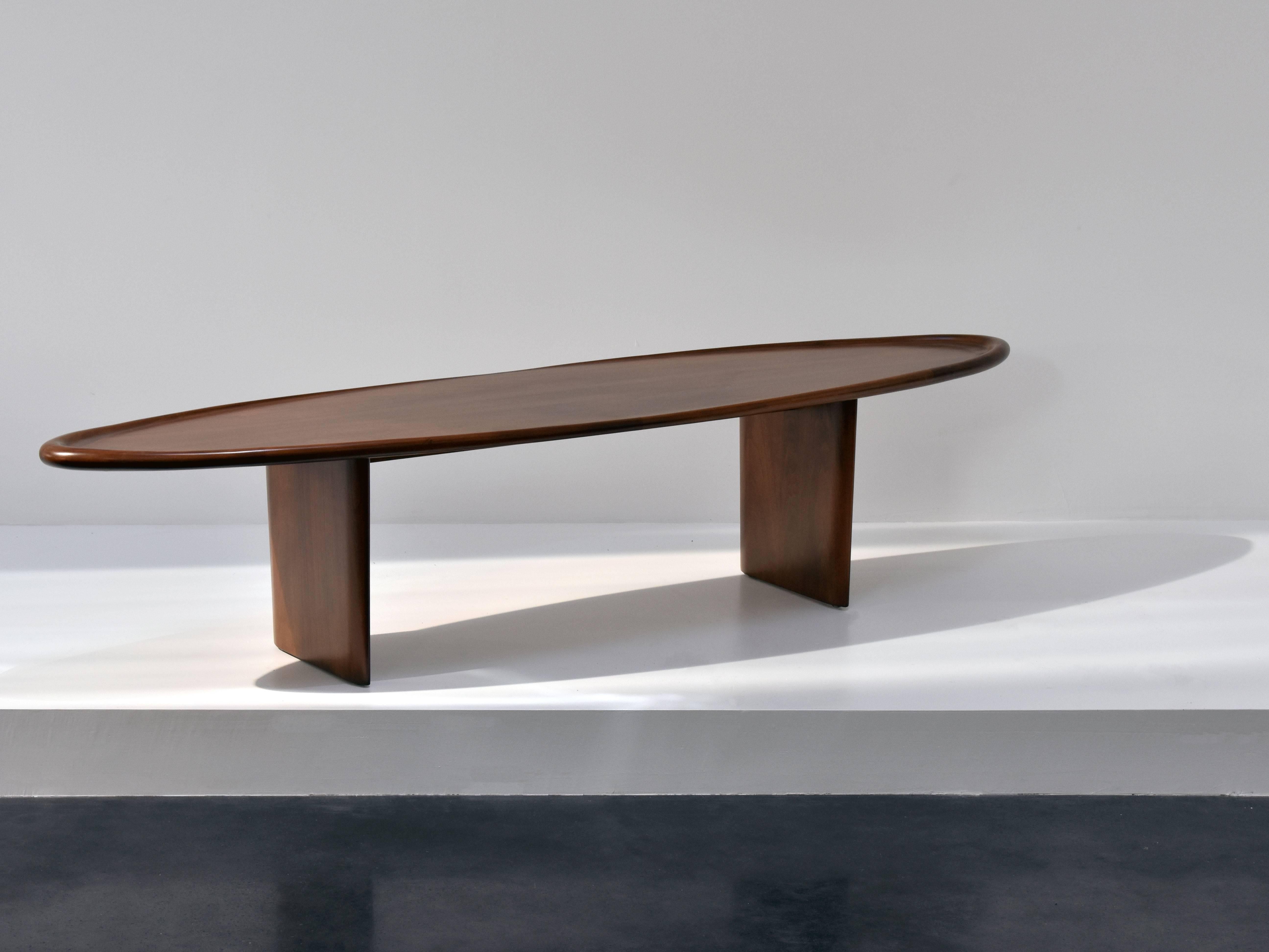 A walnut coffee table by T.H. Robsjohn-Gibbings in a symmetrical rounded form. Manufactured by American Widdicomb Furniture Company.