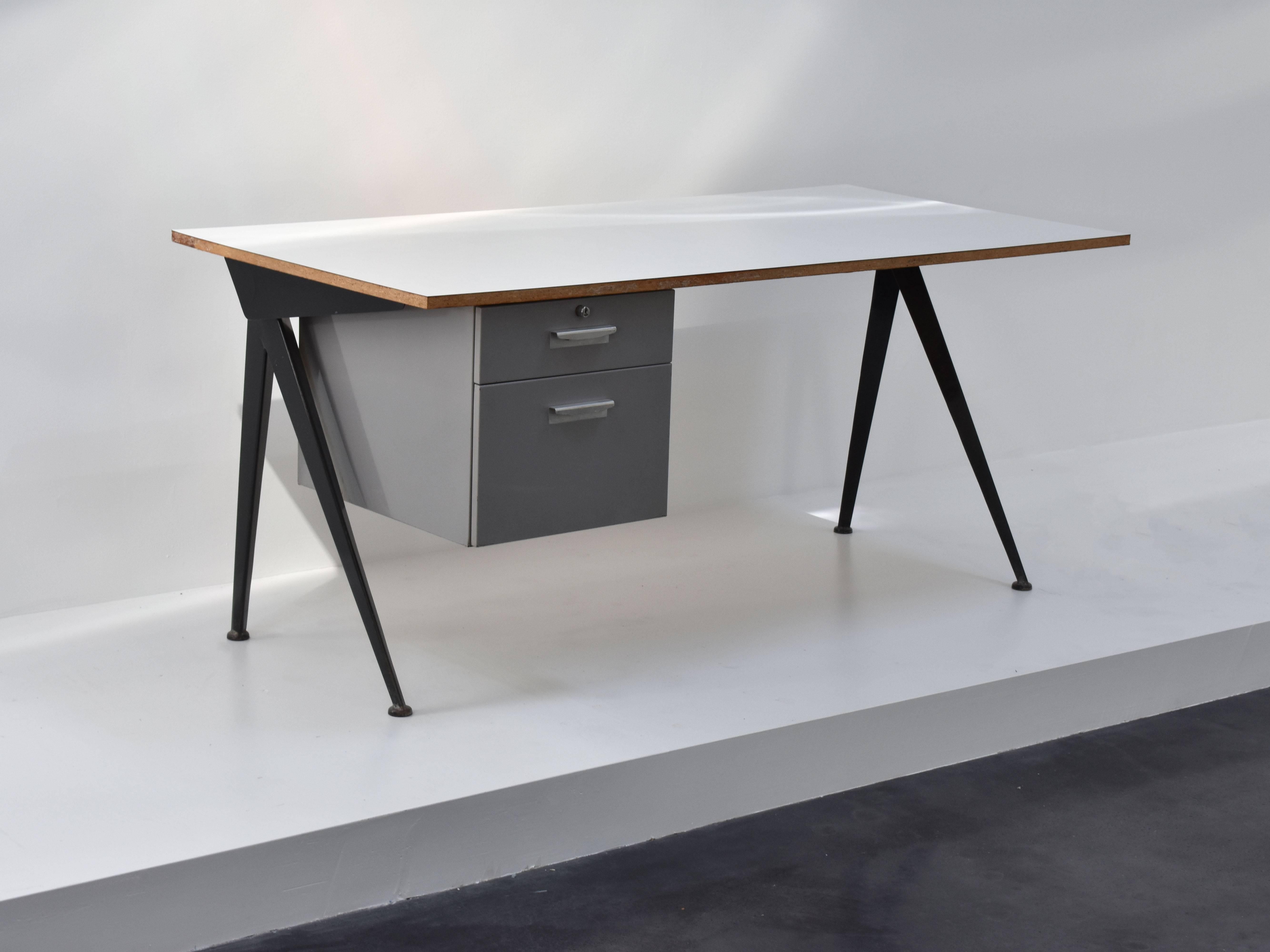 Manufactured by Les Ateliers Jean Prouvé, Nancy, France. Circa 1953, black coated steel sheet base, white Formica top, grey lacquered metal container with two drawers. An excellent example of French post war design.

Litterature.: cf. P. Sulzer,