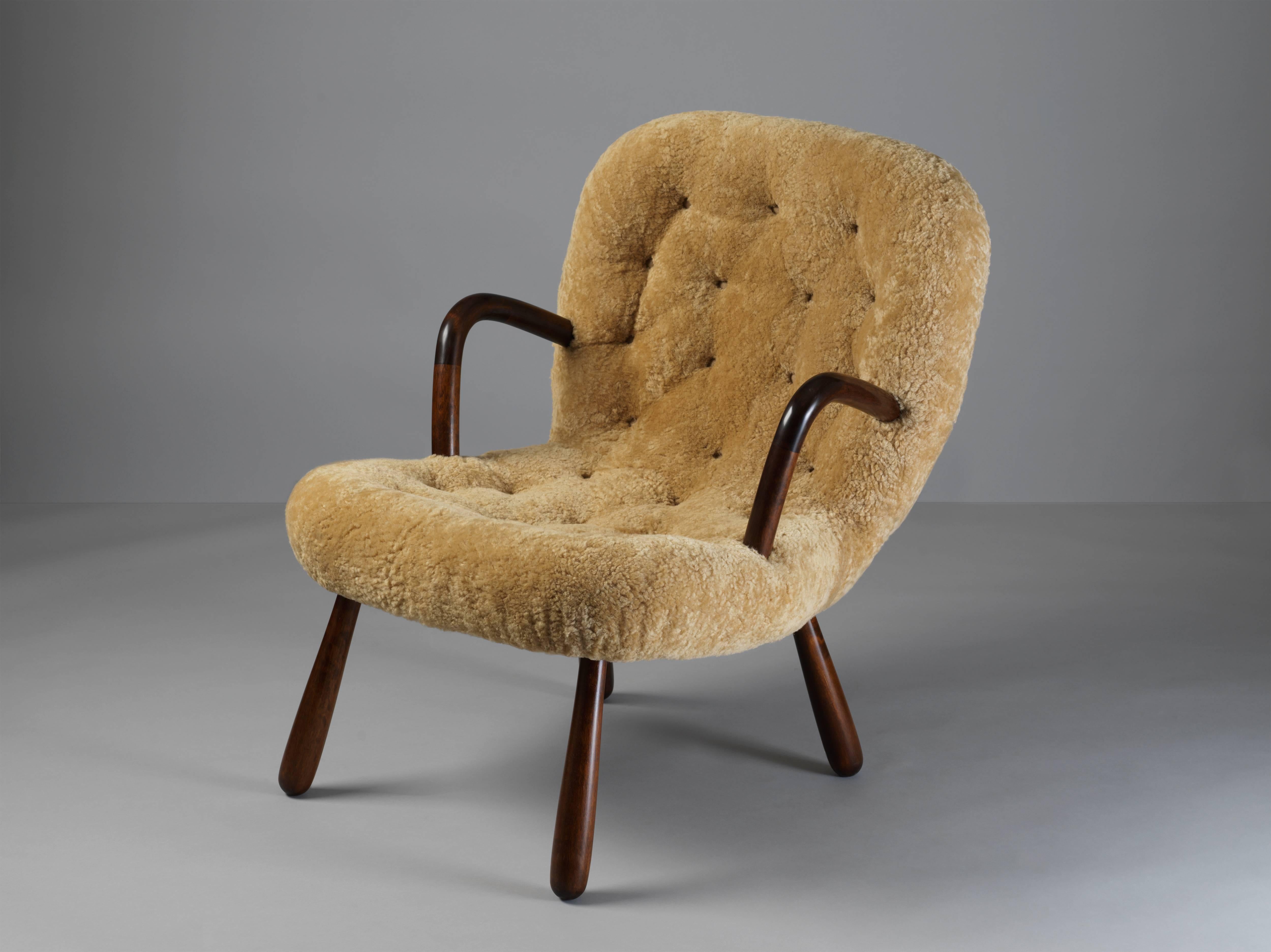 An unusual organic lounge chair / clam chair, attributed to Philip Arctander. Dark stained beech frame, upholstered in natural beige sheepskin.

Philip Arctander had associations with Danish architects such as Flemming and Mogens Lassen and Arne