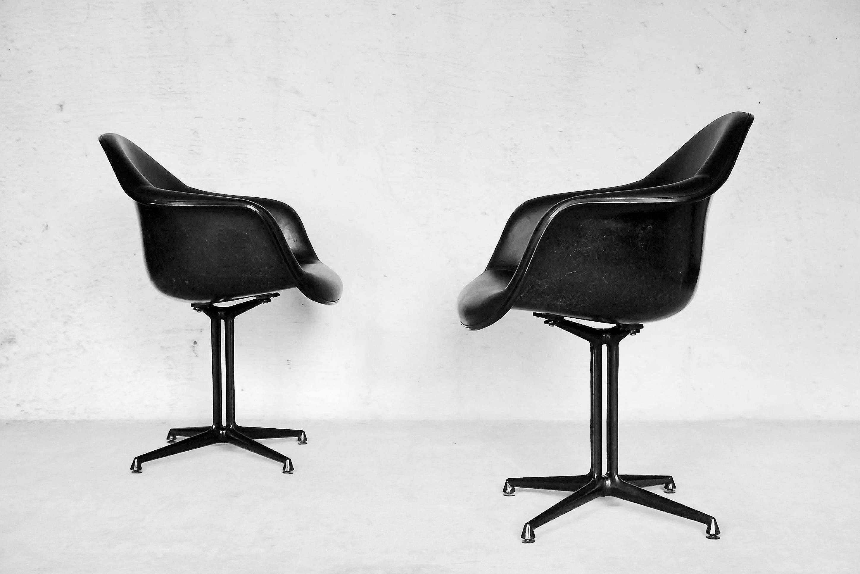 This set of two La Fonda chairs was designed by Charles and Ray Eames for Herman Miller during the 1960s. The designers set to work on this model in response to a request from their friend Alexander Girard, who needed seating for his new restaurant,