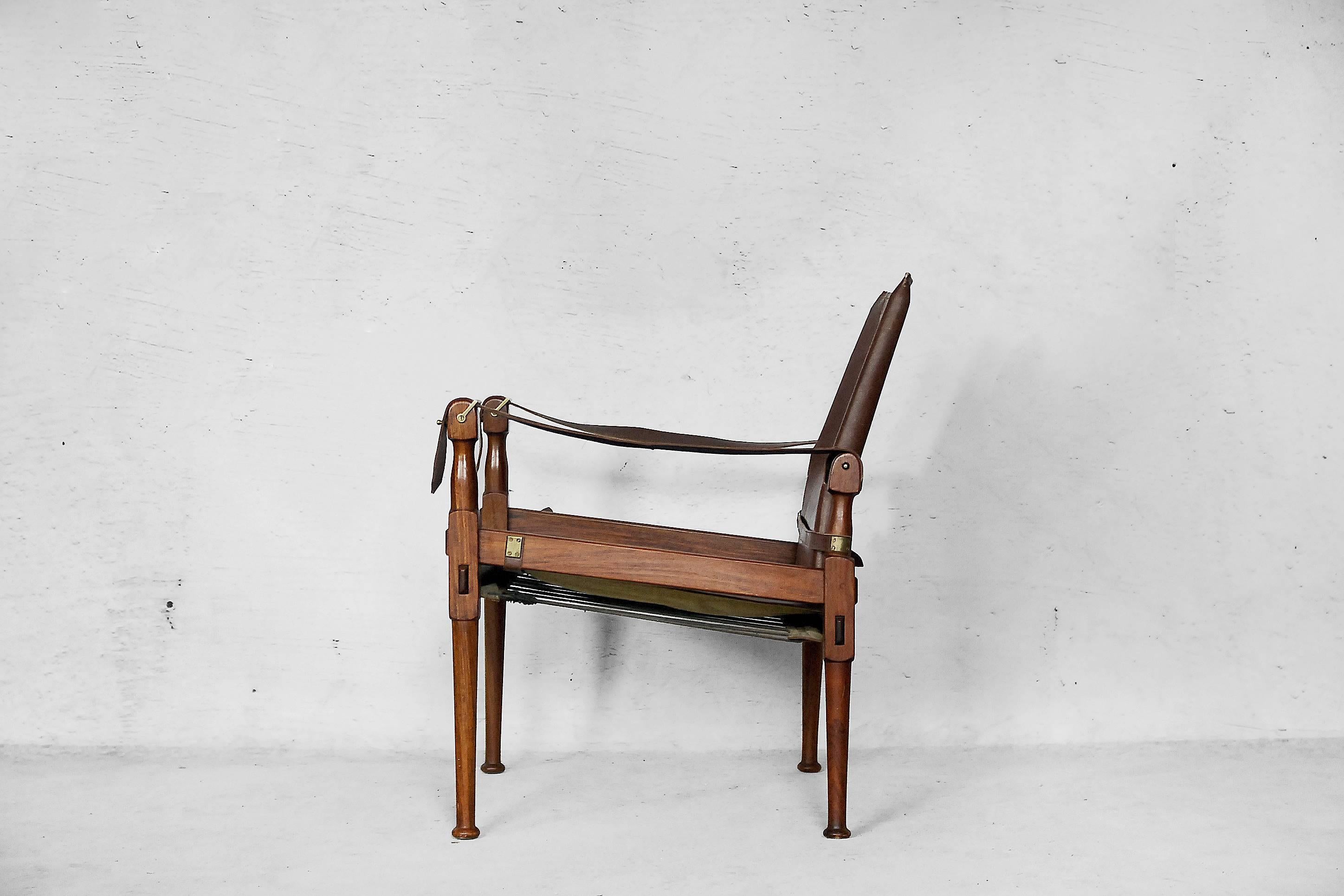 This rosewood and leather campaign chair was manufactured during the 1970s by M. Hayat & Bros. The chair has a wooden frame with a leather seat, back, and arms and brass hardware. This safari chair has a strong grain to the wood and natural patina