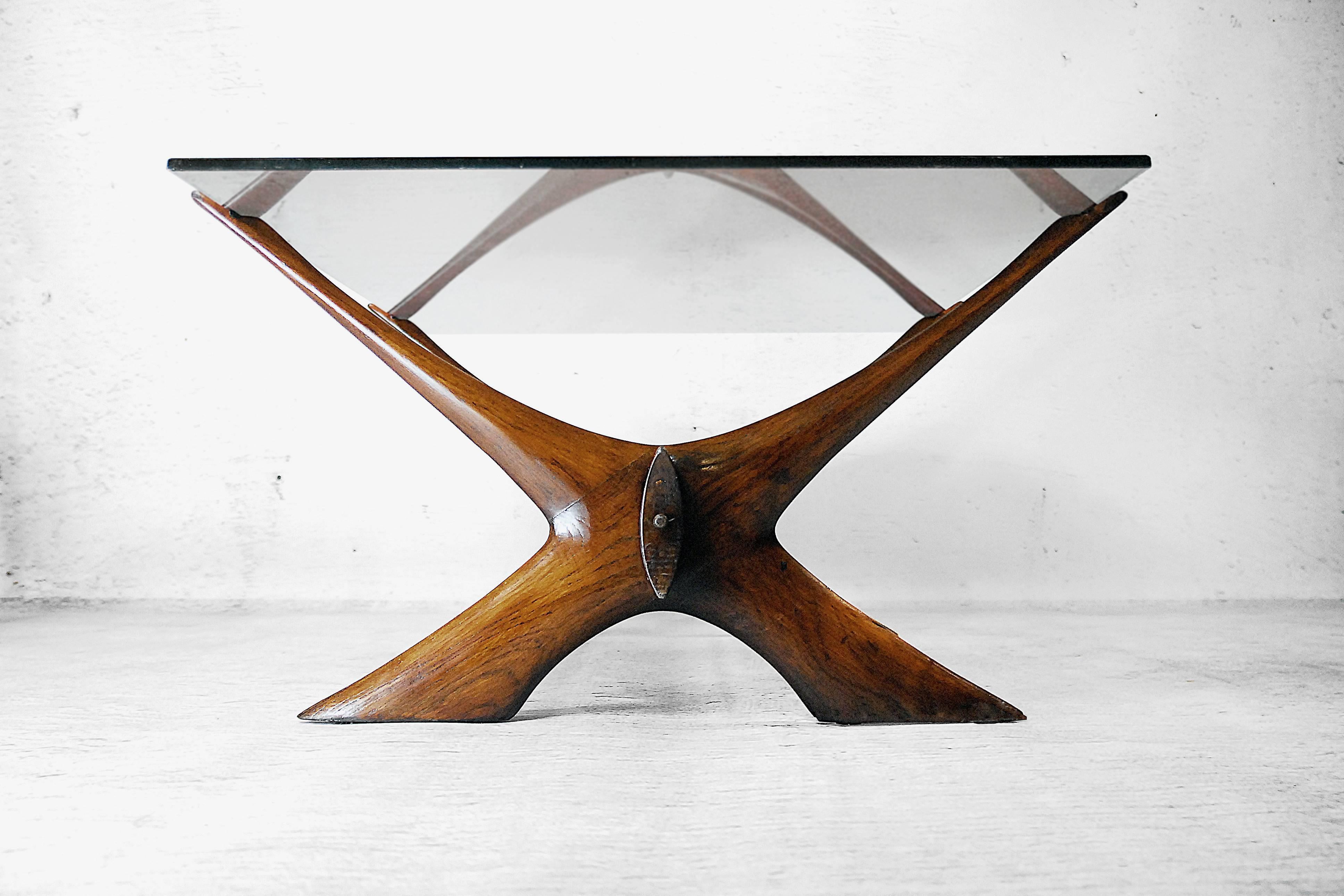 This sculptured organic Danish coffee table was designed by Illum Wikkelsø. Manufactured by Søren Willadsen, who also produced designs for Finn Juhl and Nanna Ditzel, it is handcrafted from solid walnut. The distinct frame is contrasted by a linear