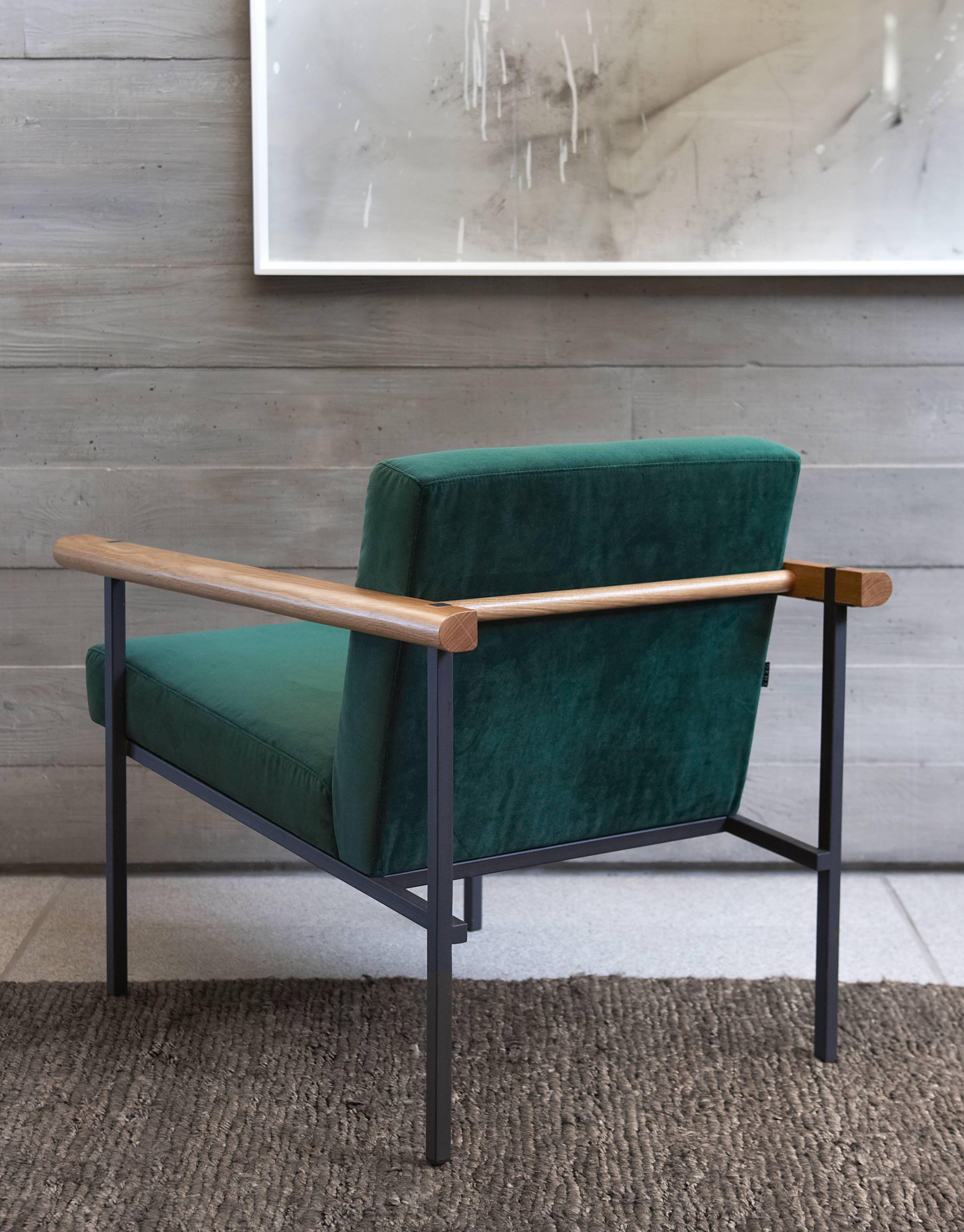 A rectilinear metal structure supports a leather upholstered, floating seat. The solid timber arms are crafted from a selection of quality woods. The character of the Ray armchair is one of taught clarity and essential lines. The combination of